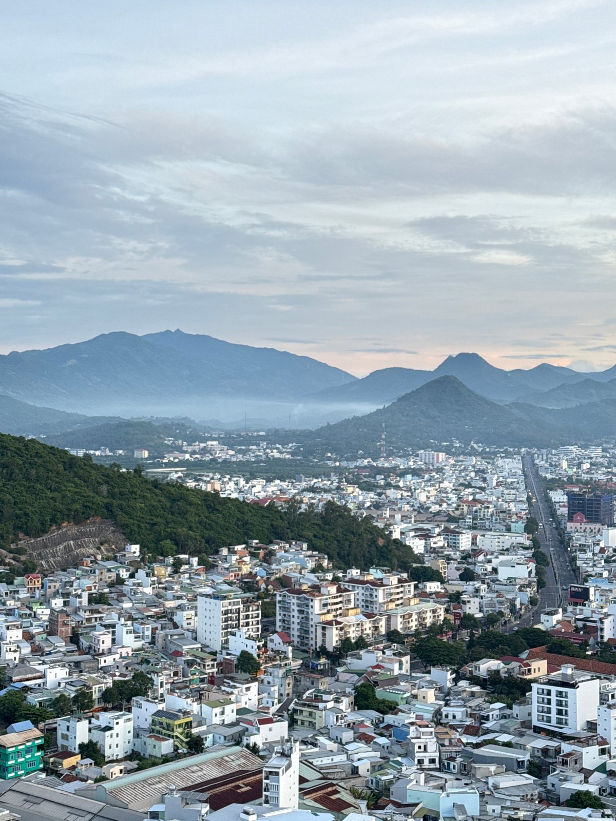 Dusk aerial survey of Nha Trang's coastline and city grid
