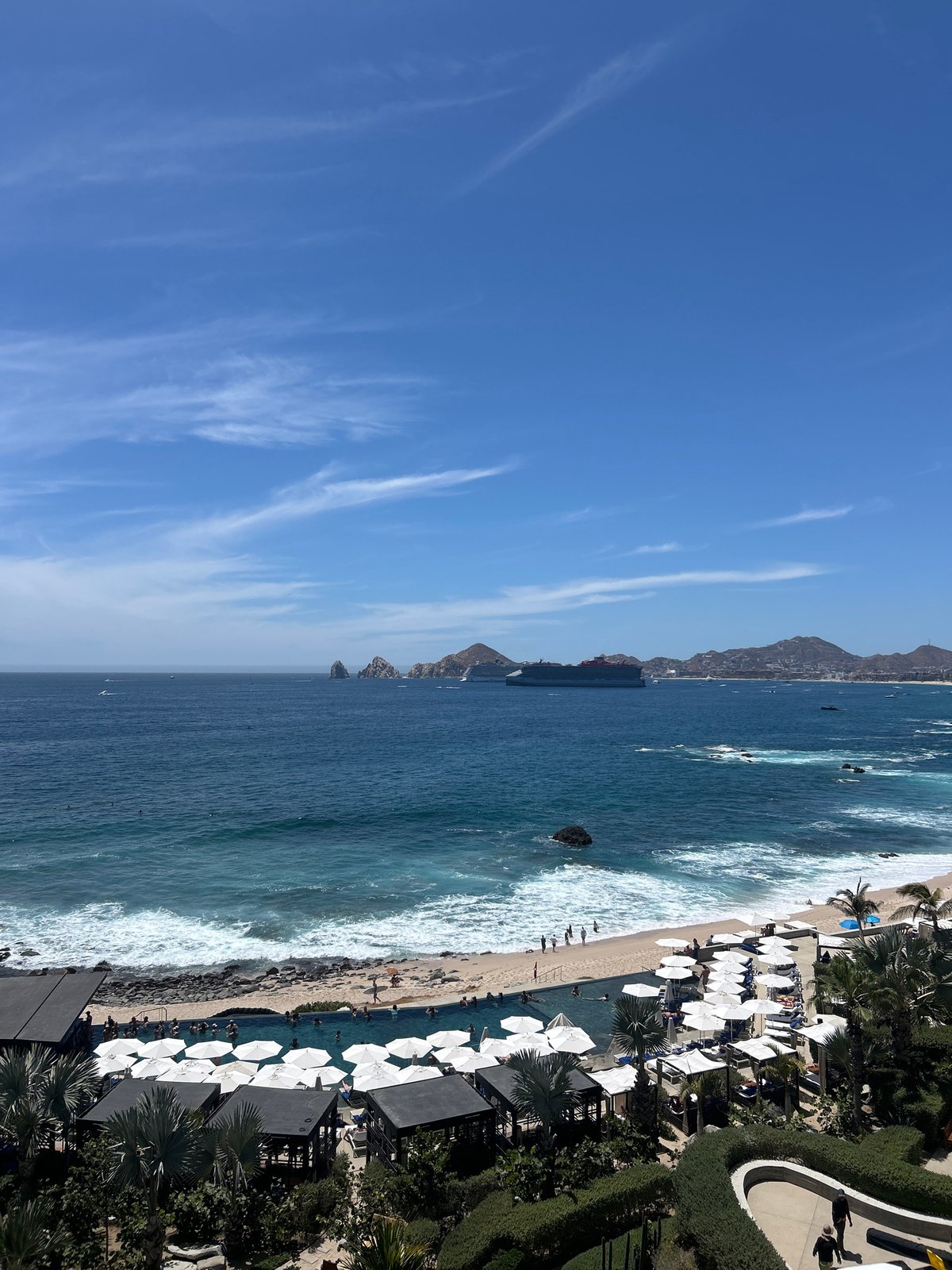 Aerial views capture Cabo San Lucas coastline under clear skies