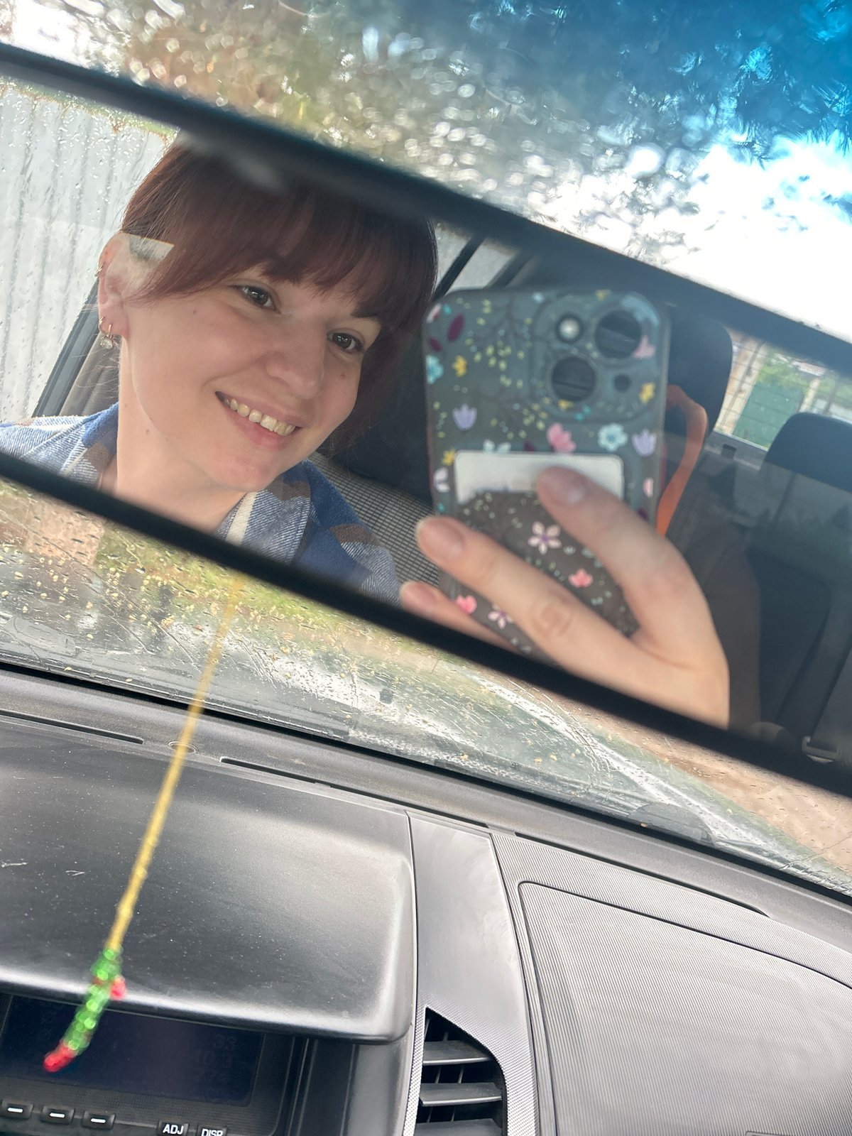 Woman takes car selfies during rainfall in Фоки, Russia