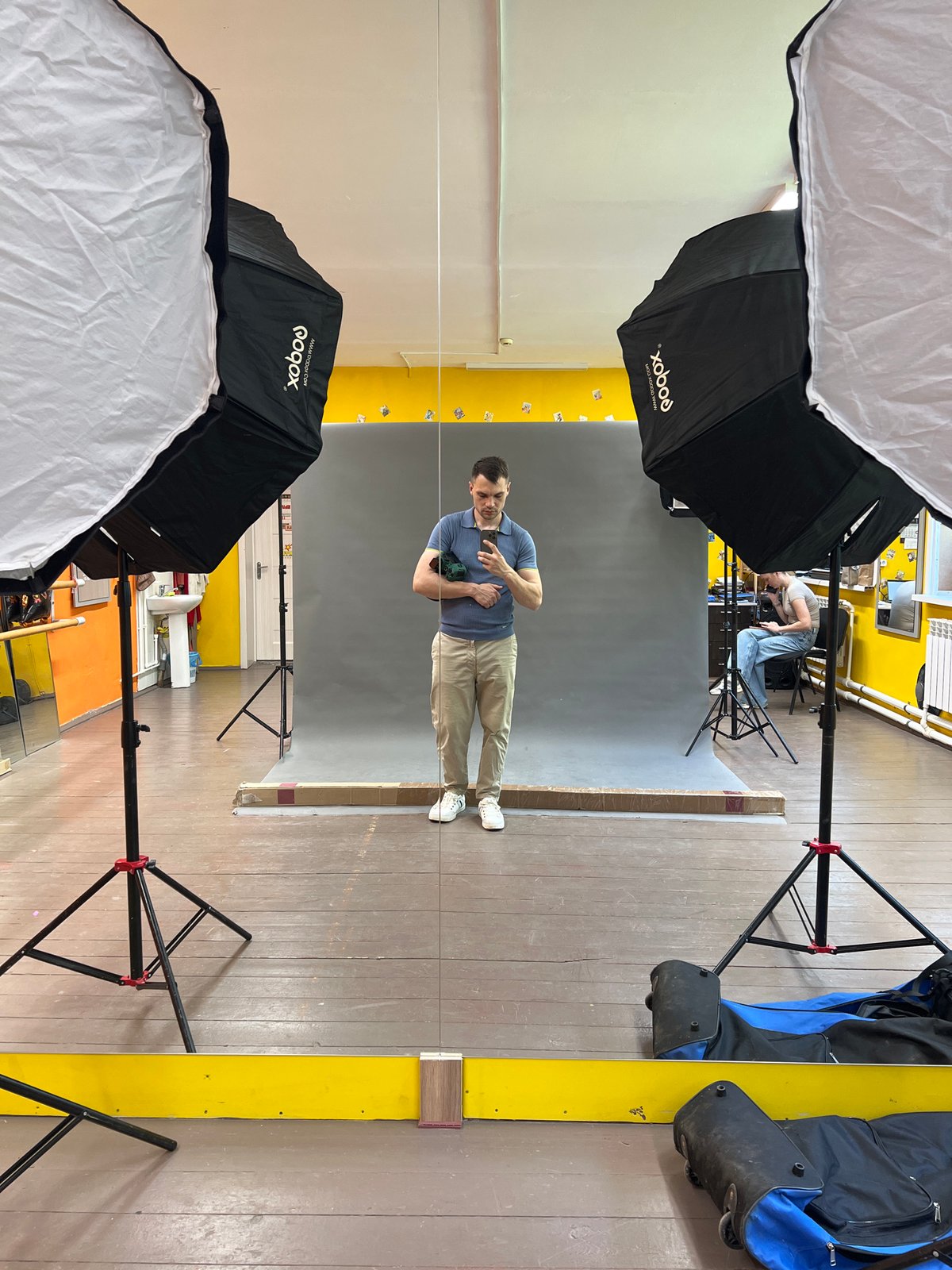 Man takes mirror selfie at photography studio in Russia