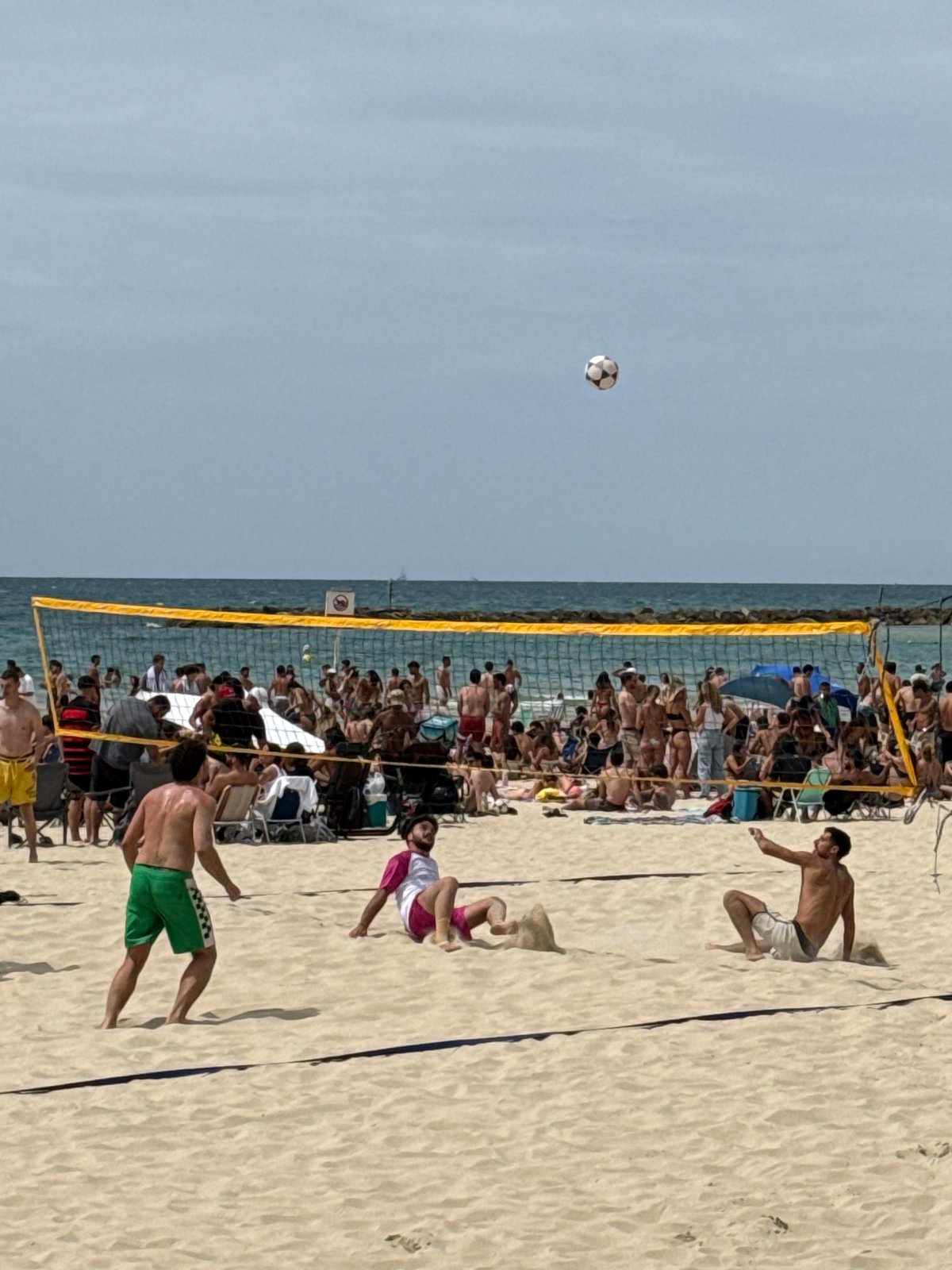 Tel Aviv scenes: beach volleyball game, damaged building observed