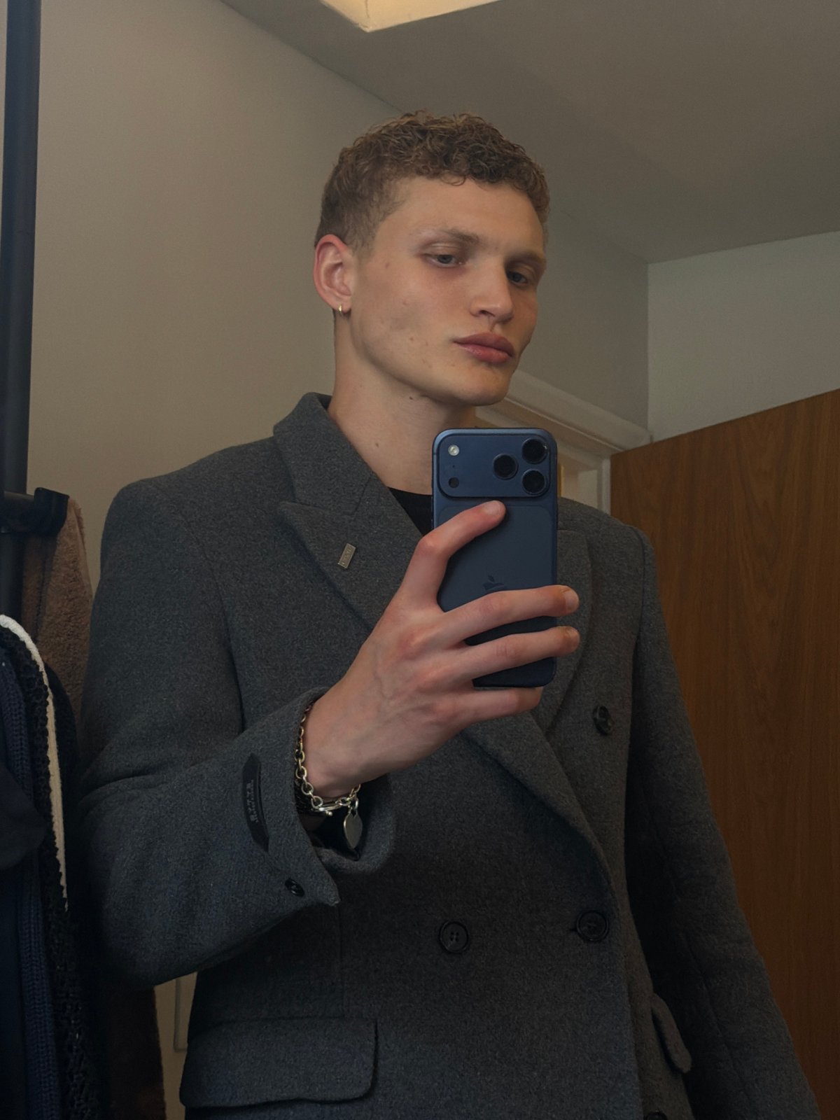 Young man takes mirror selfie in London