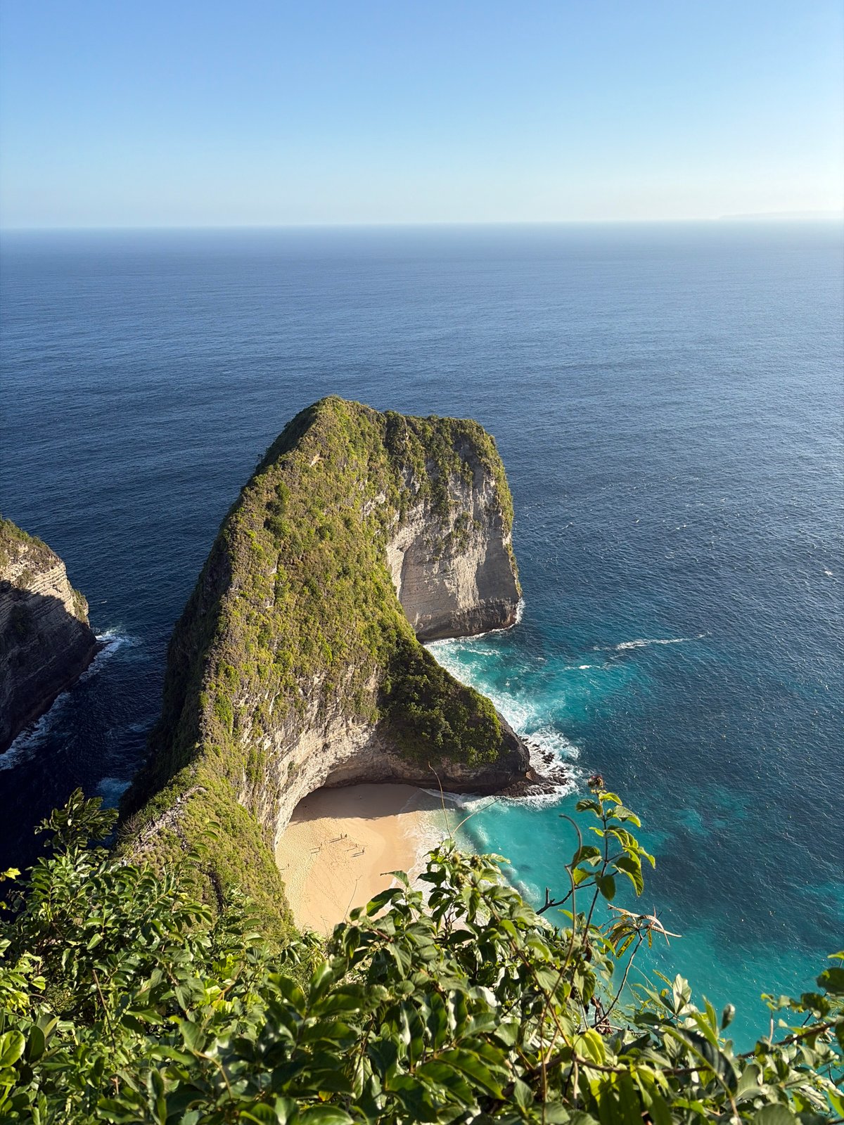 Aerial views of Kelingking Beach's iconic cliff, Nusa Penida