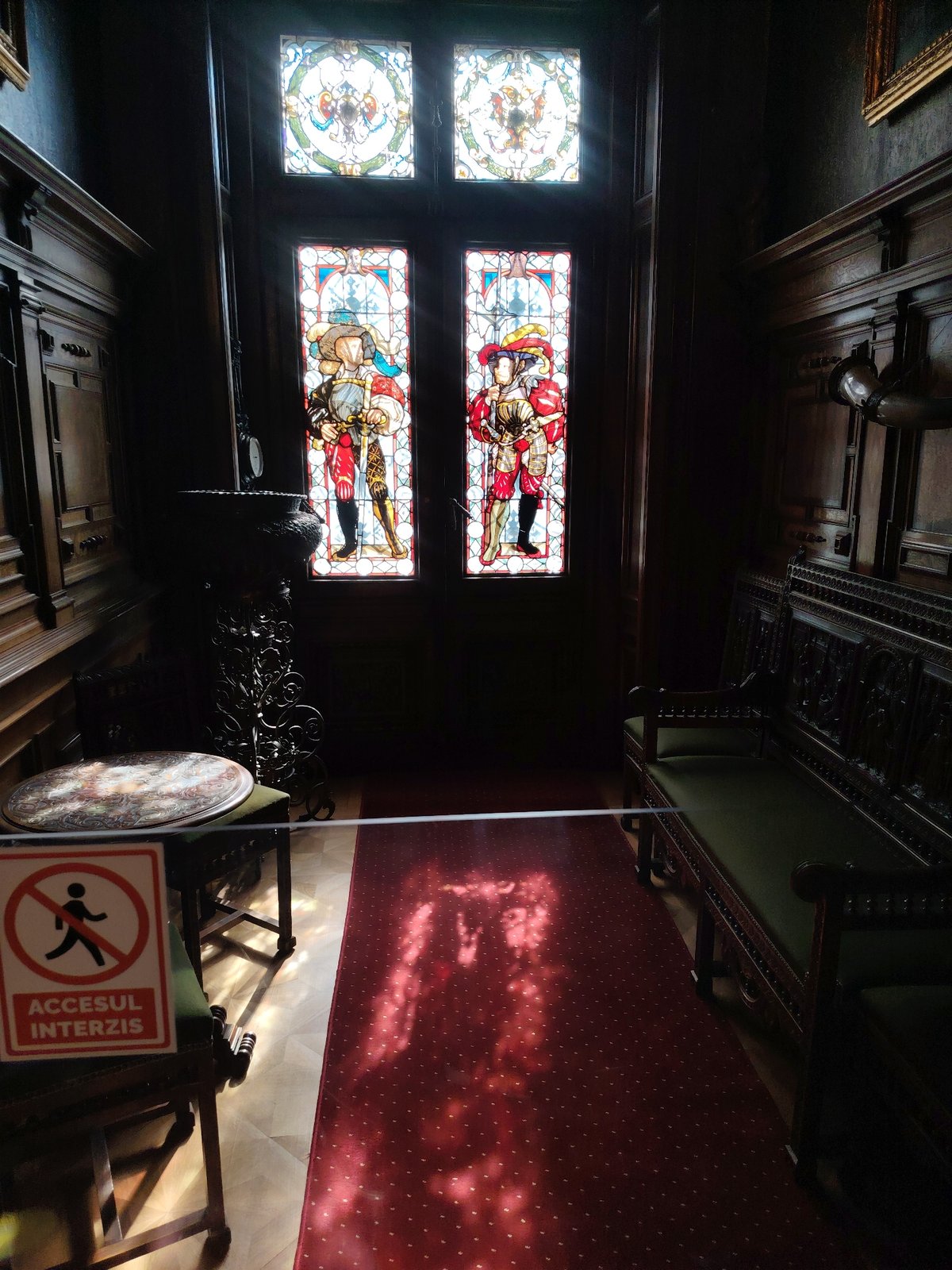 Visitor documents ornate interiors at Peleș Castle, Romania