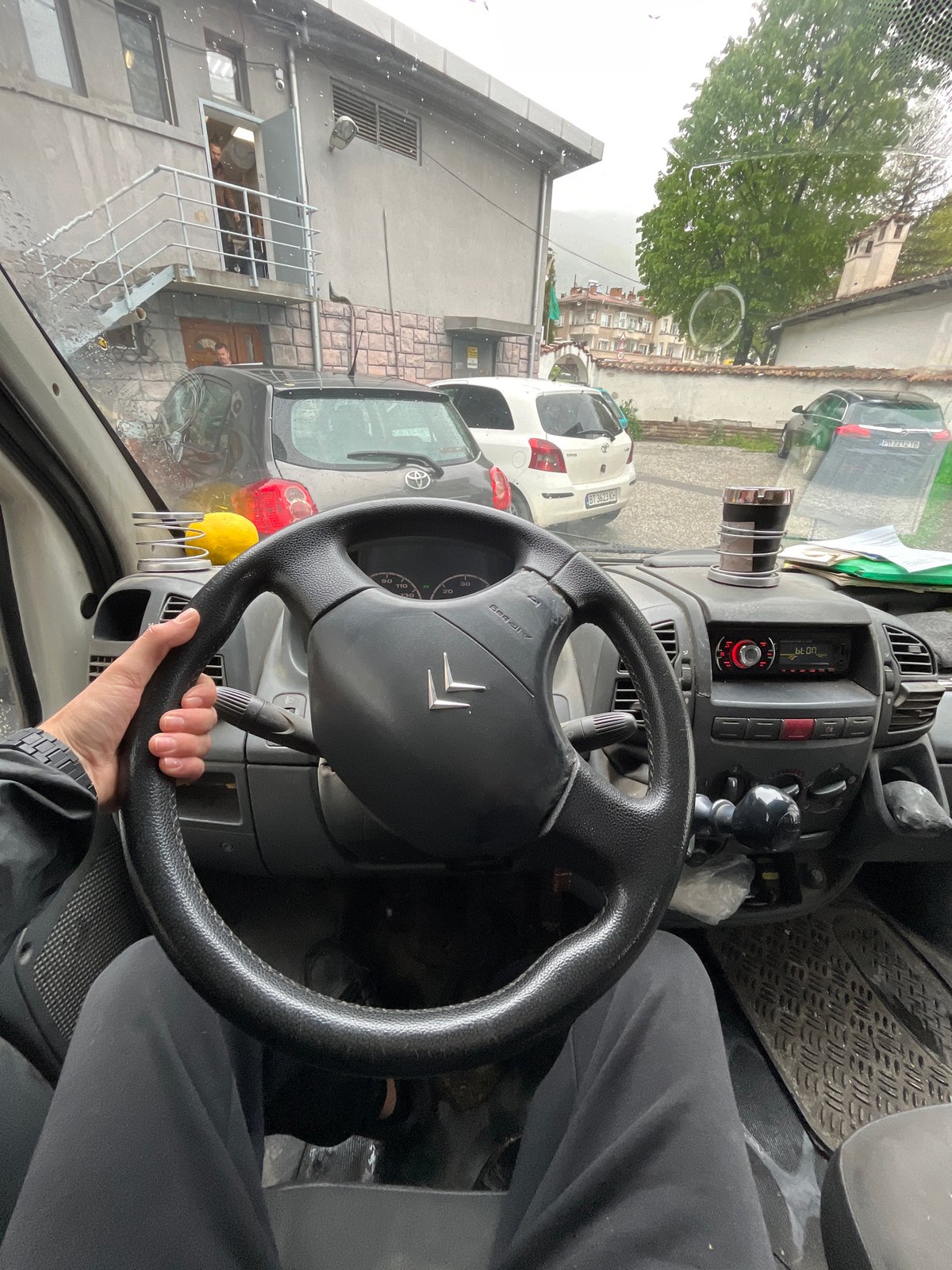 Driver documents rainy journey through Karlovo, Bulgaria streets