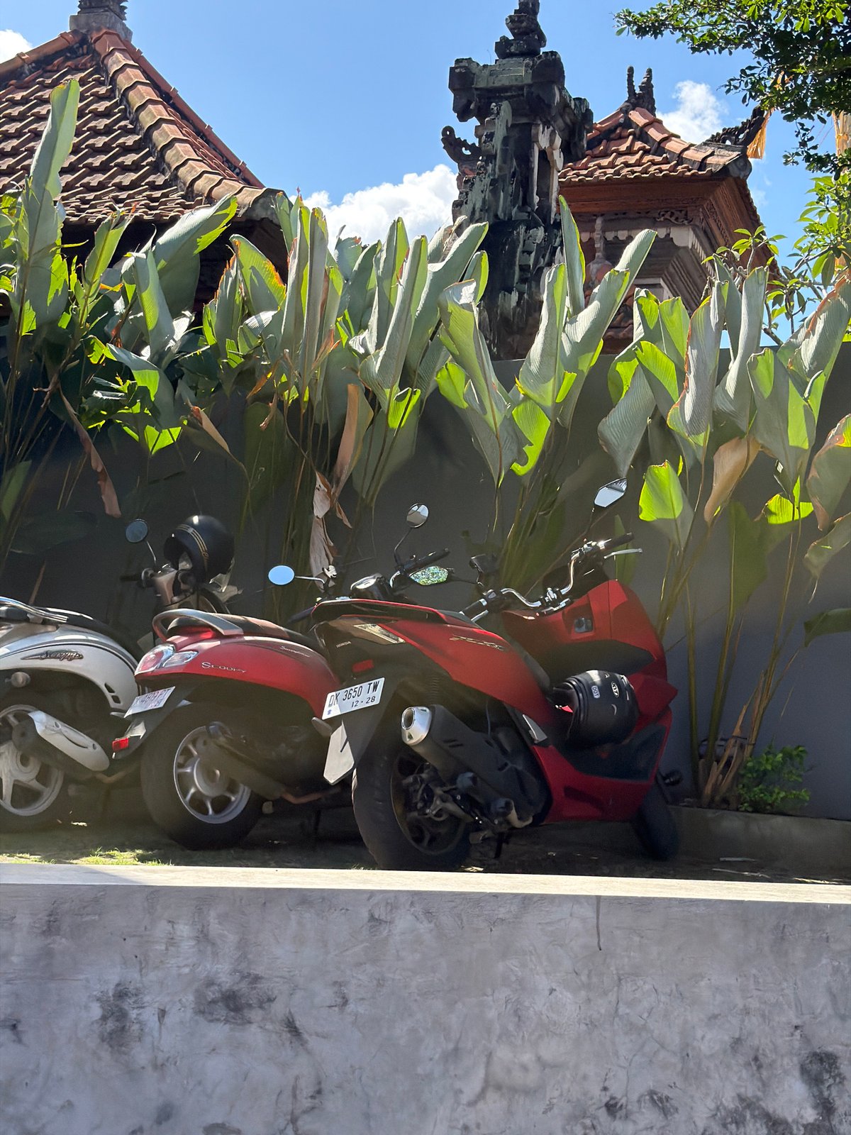 Scooters parked and moving through Kuta Selatan streets