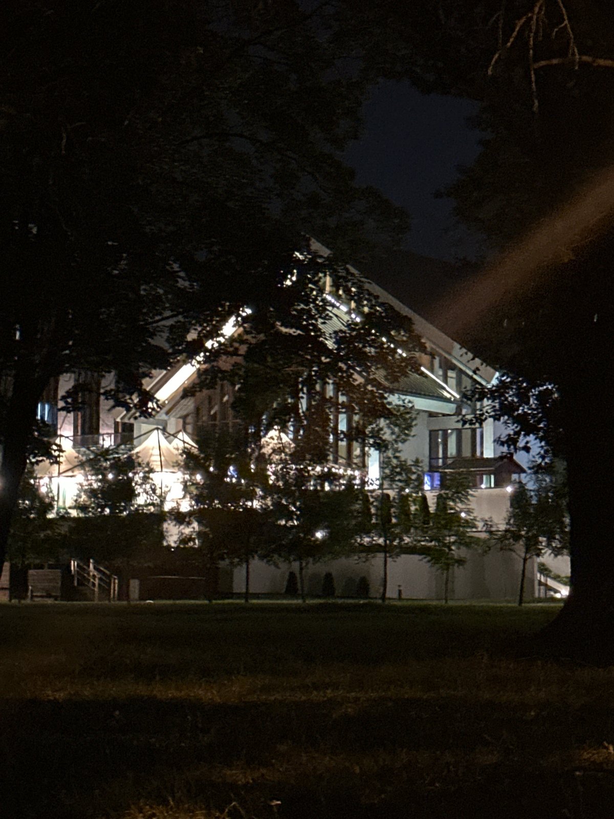 Evening stroll around a lit waterfront park and modern building