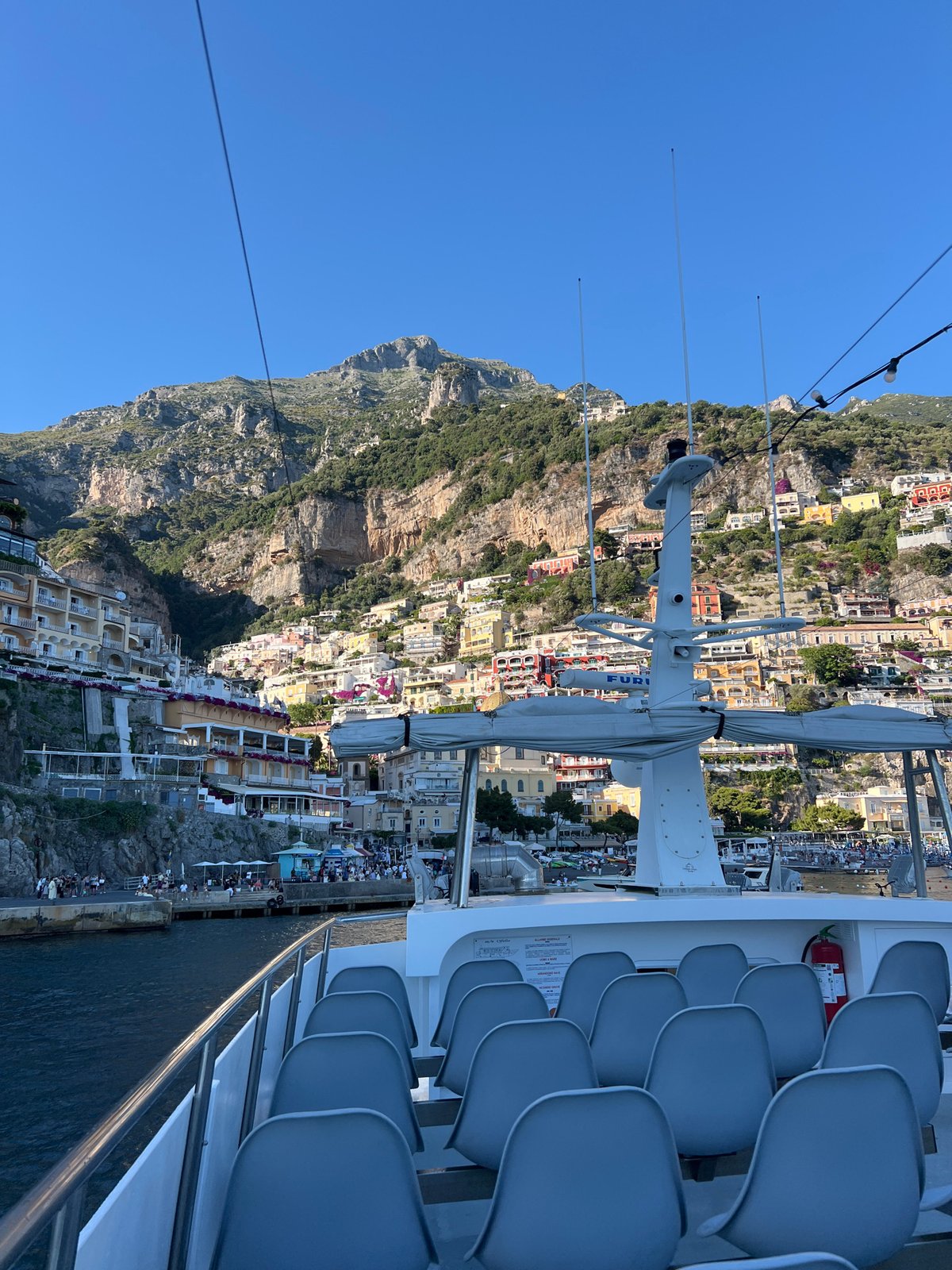 Tourist boat passengers document scenic Arienzo coastline views