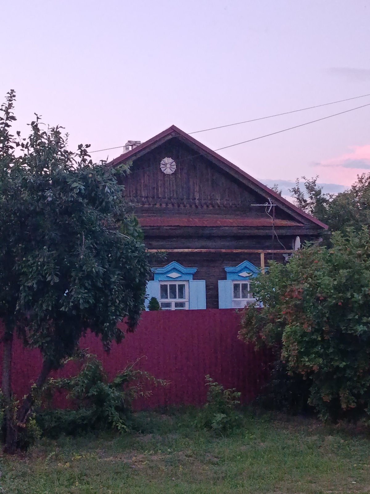 Quiet residential street in Saratov at dusk, July 2026