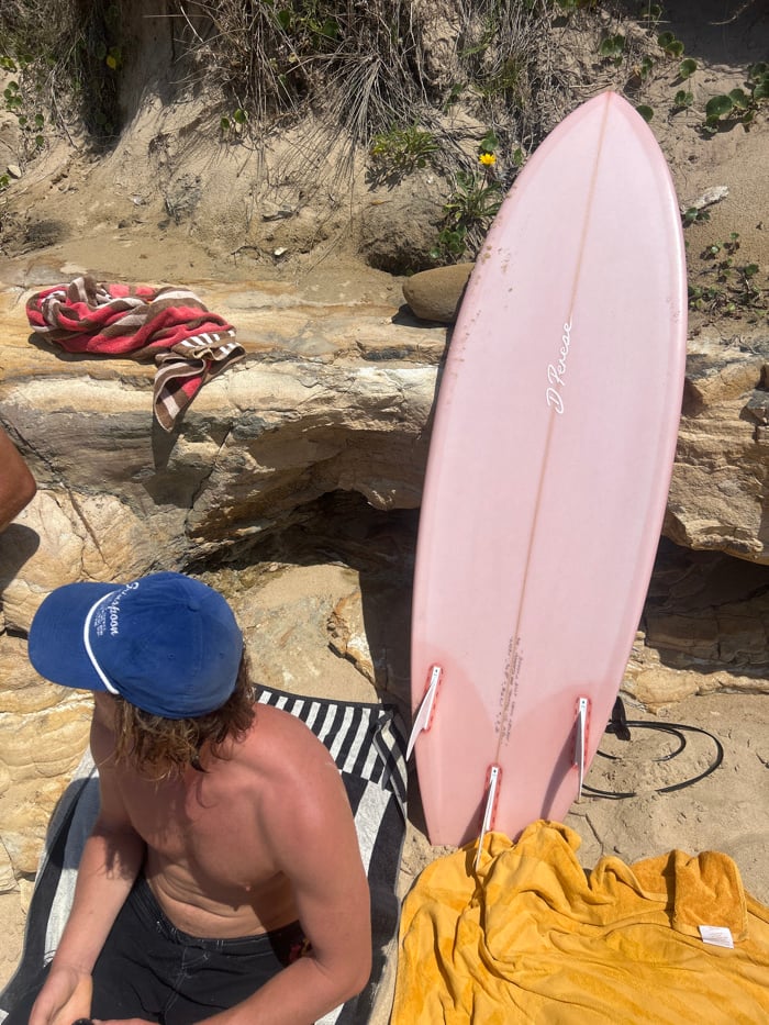 Late-night beach gathering recorded at Bulli with surfboards, towels
