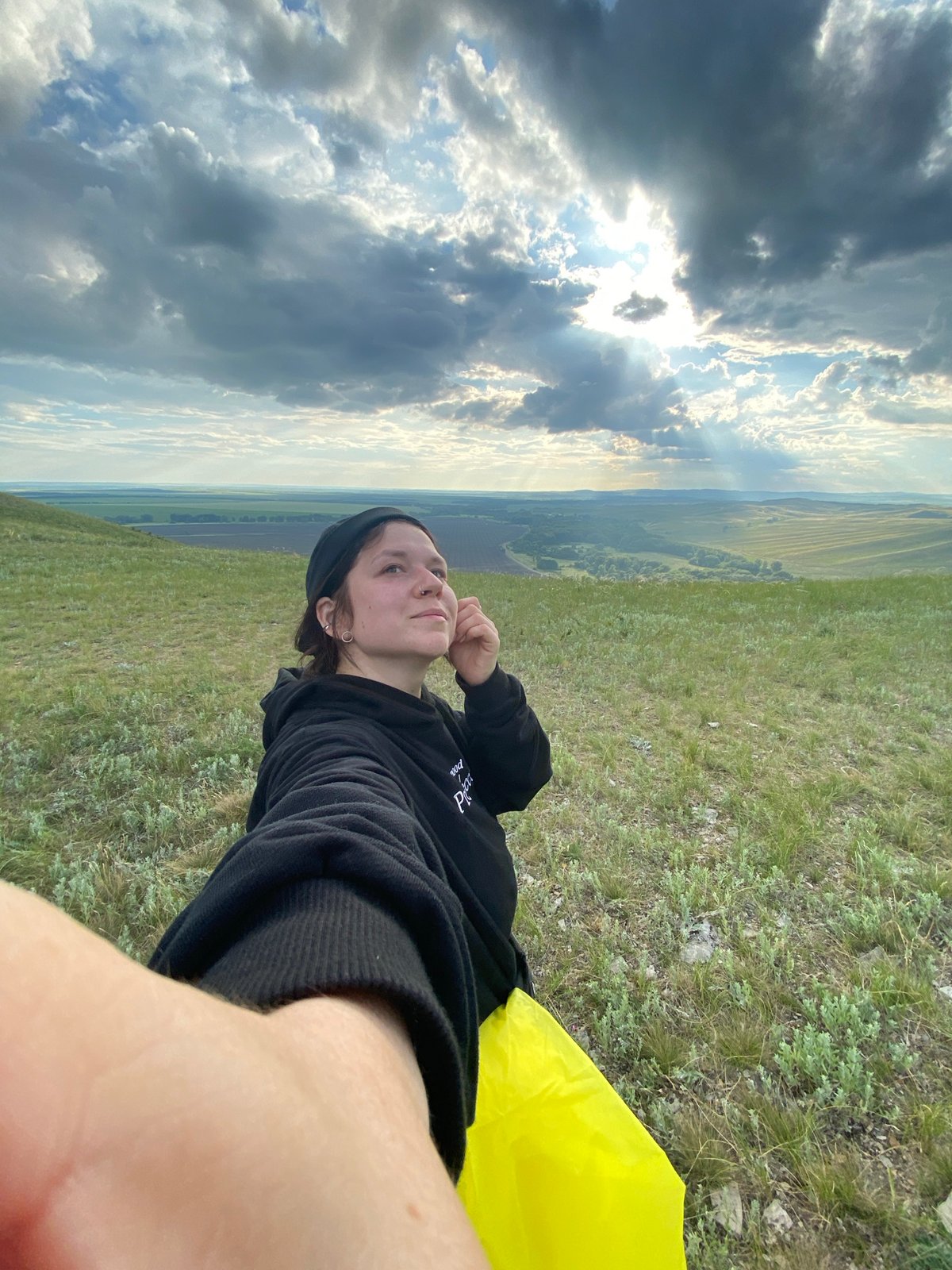 Woman documents afternoon photo session on Russian hillside