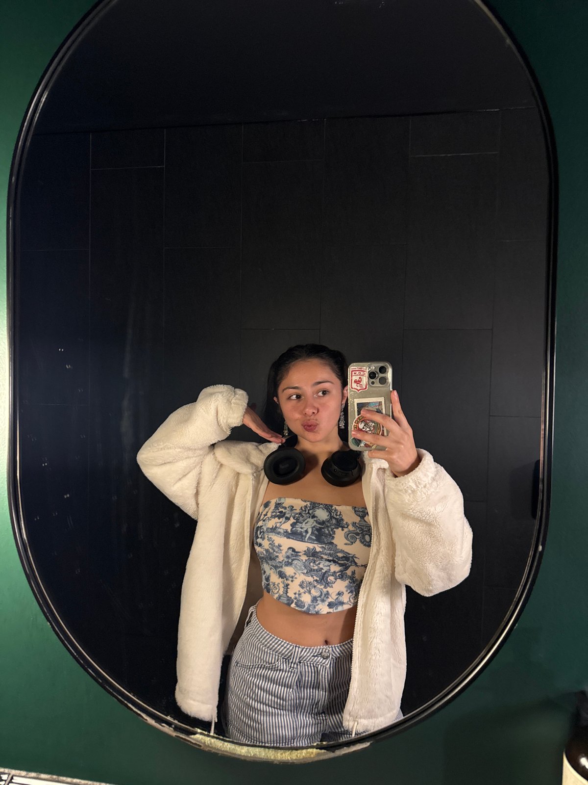 Person takes multiple mirror selfies in decorated Perth building