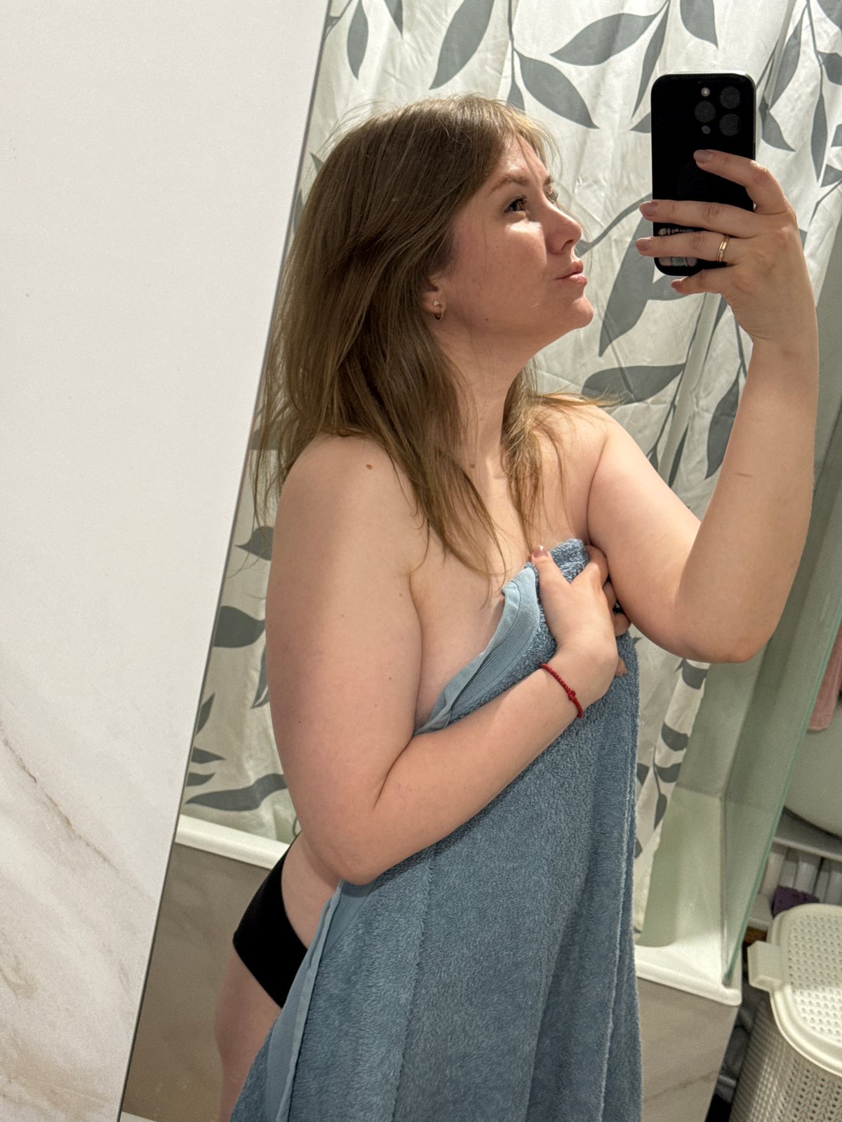 Woman photographs herself in bathroom in Gornyi, Russia