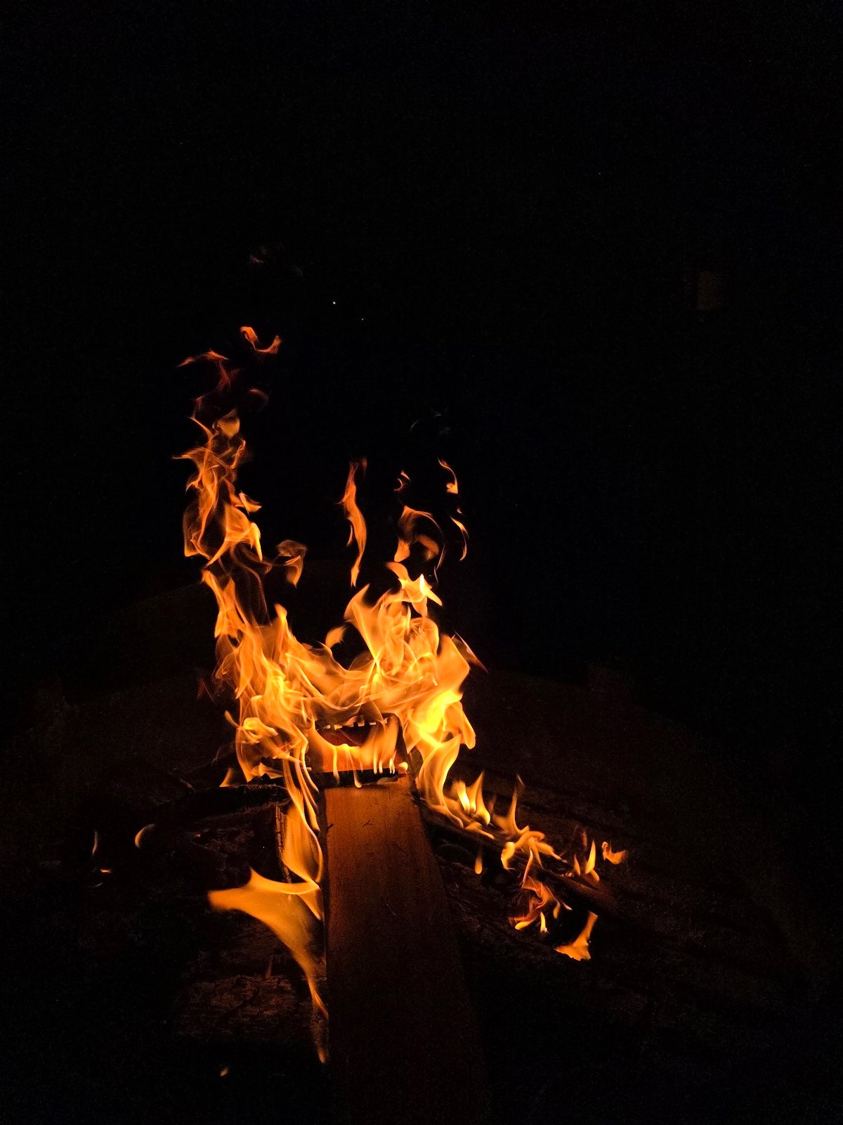 Campfire burning in a metal pit at a Russian dacha settlement