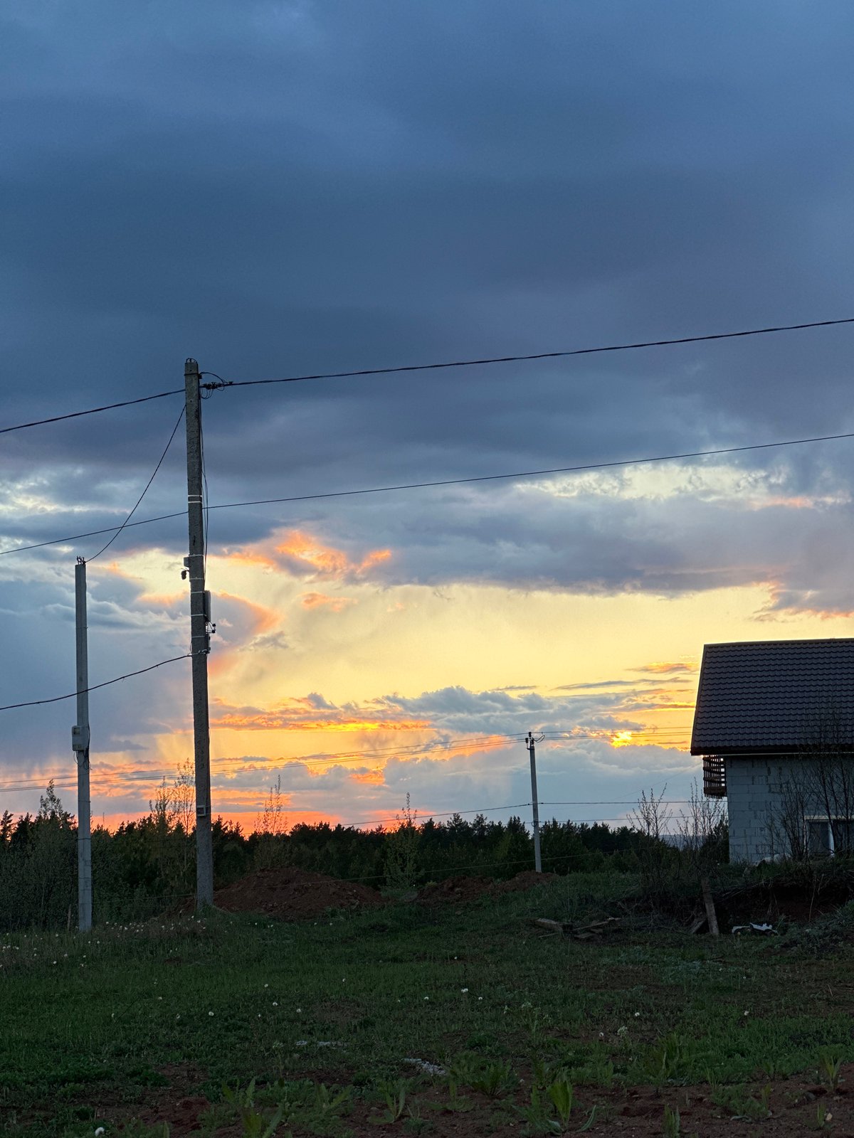 Dramatic sunset contrasts with storm clouds over Прикамский, Russia