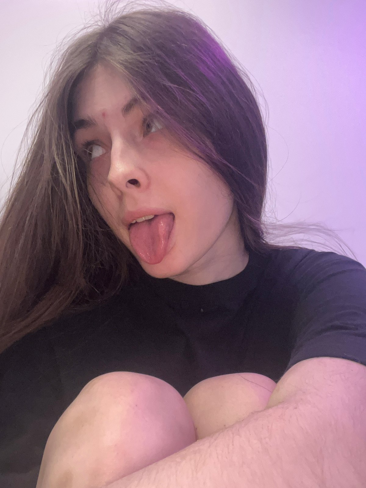 Young woman takes playful selfies in Saint Petersburg bedroom