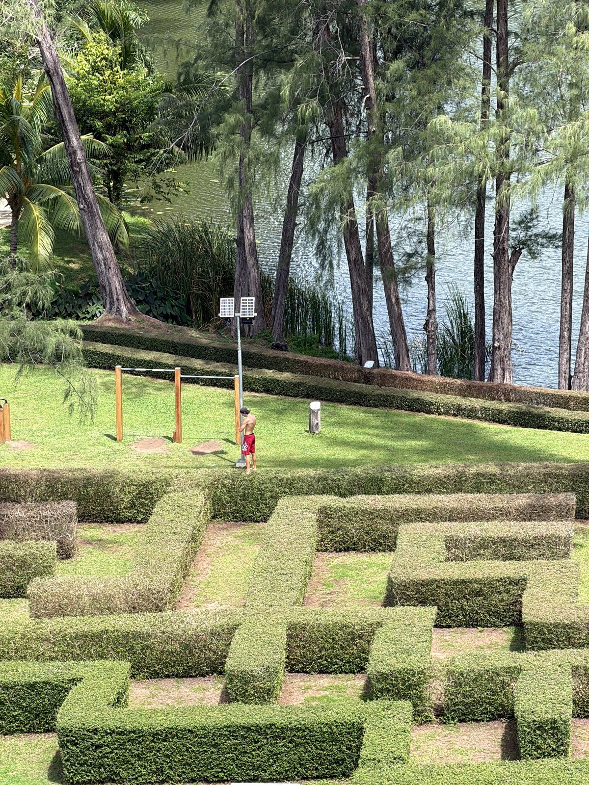 Man uses outdoor exercise facility and pool in Thailand
