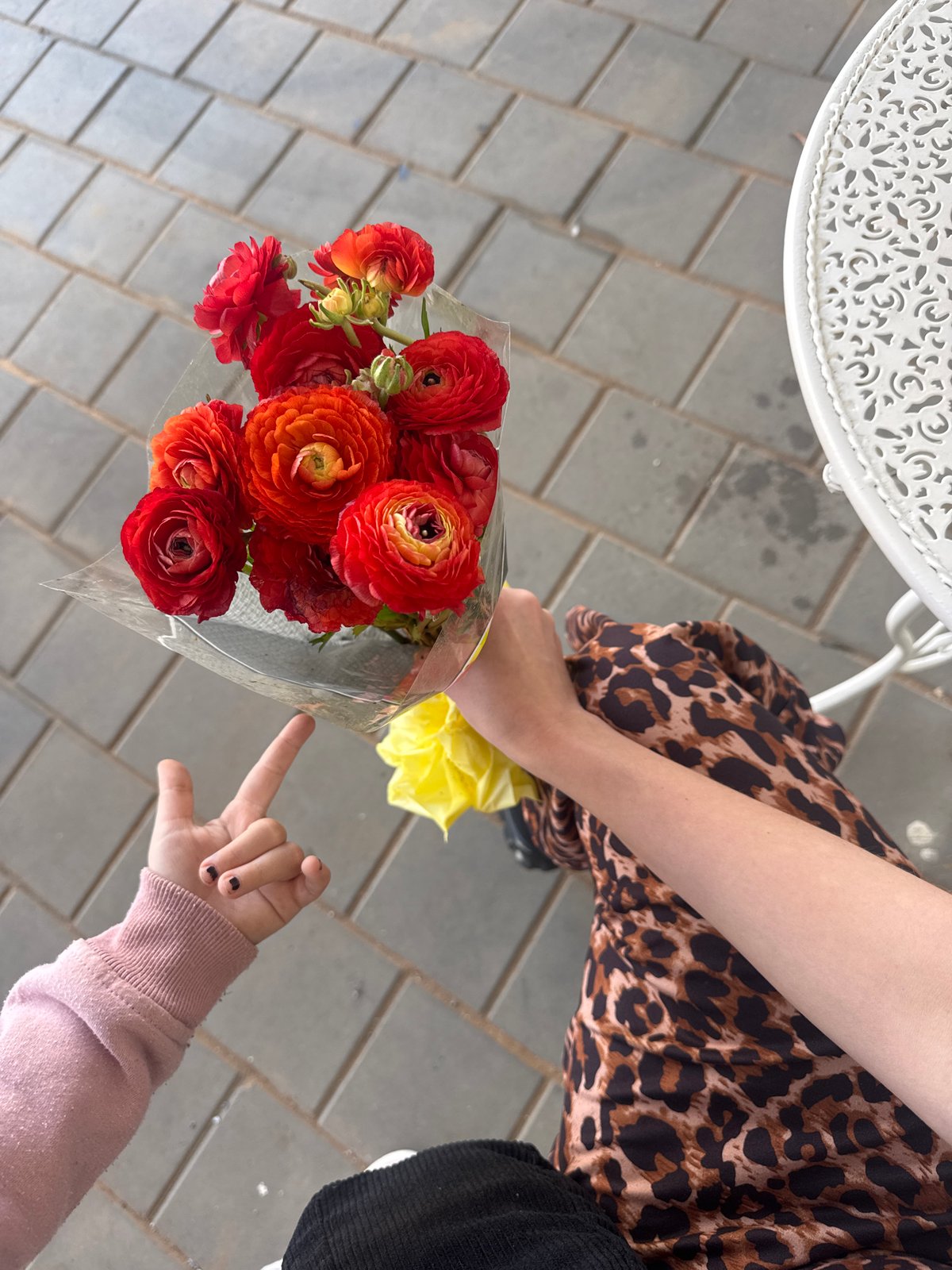 Mother and child share Friday morning flowers in Bat Yam