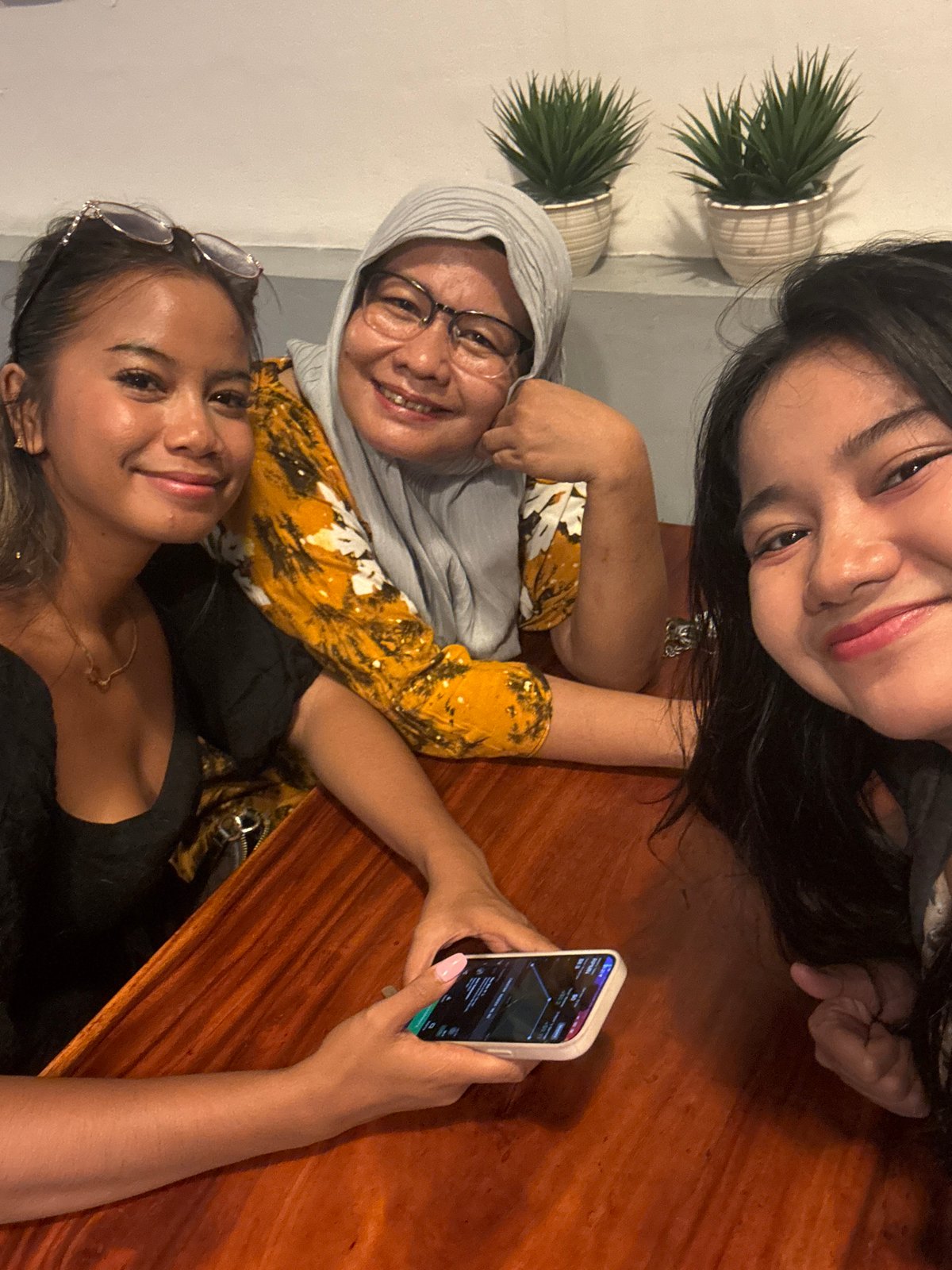 Women photograph meal at North Jakarta restaurant