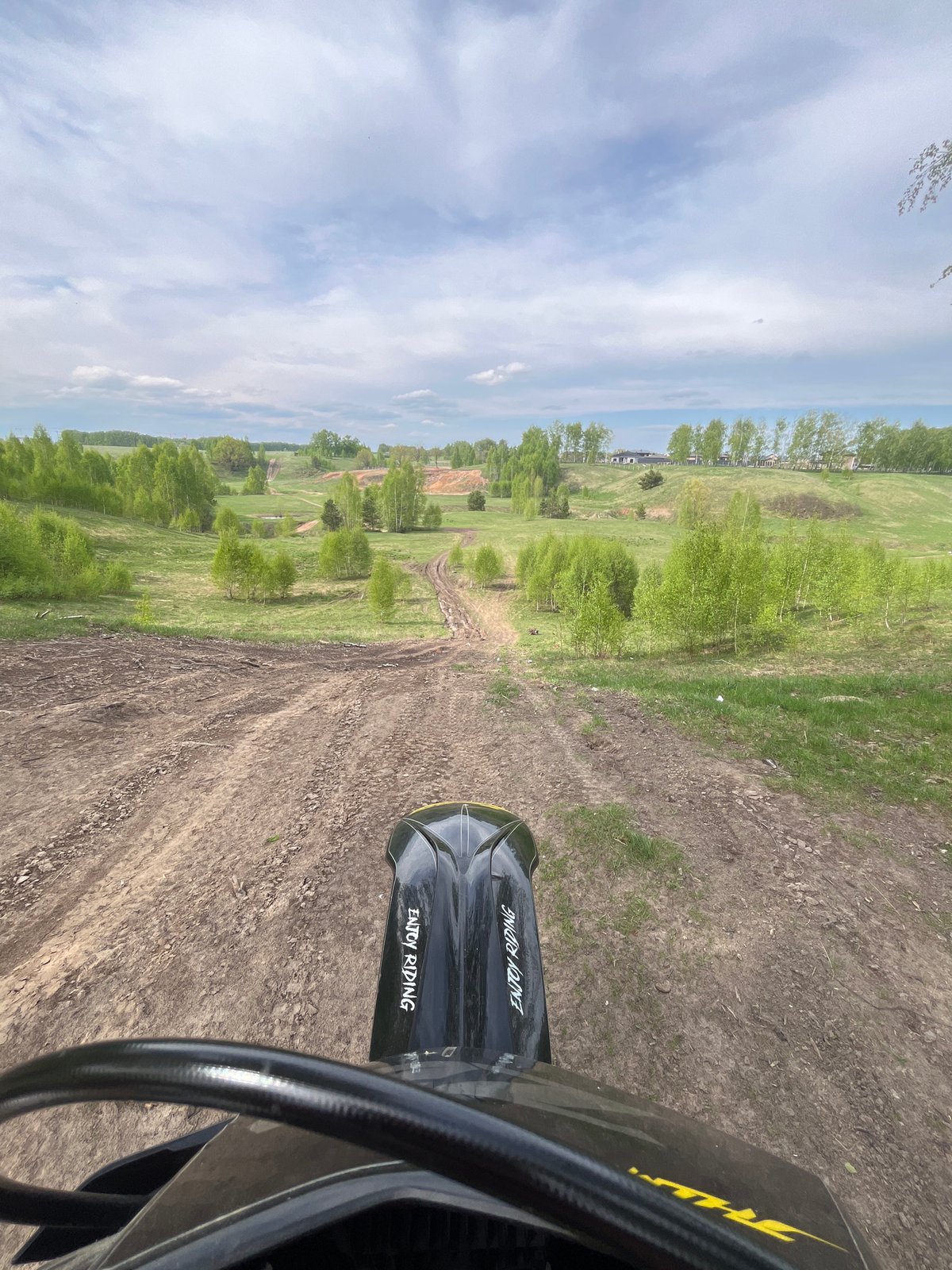 Motorcyclist rides dirt track in rural Russia