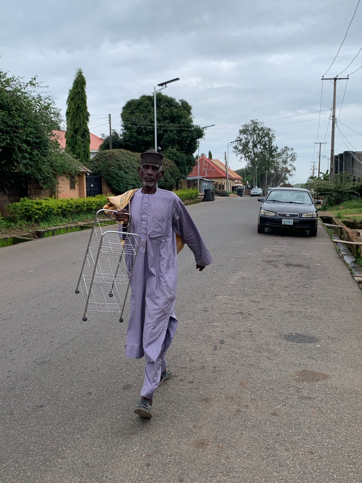 Everyday street life across a Jos neighborhood on a busy morning
