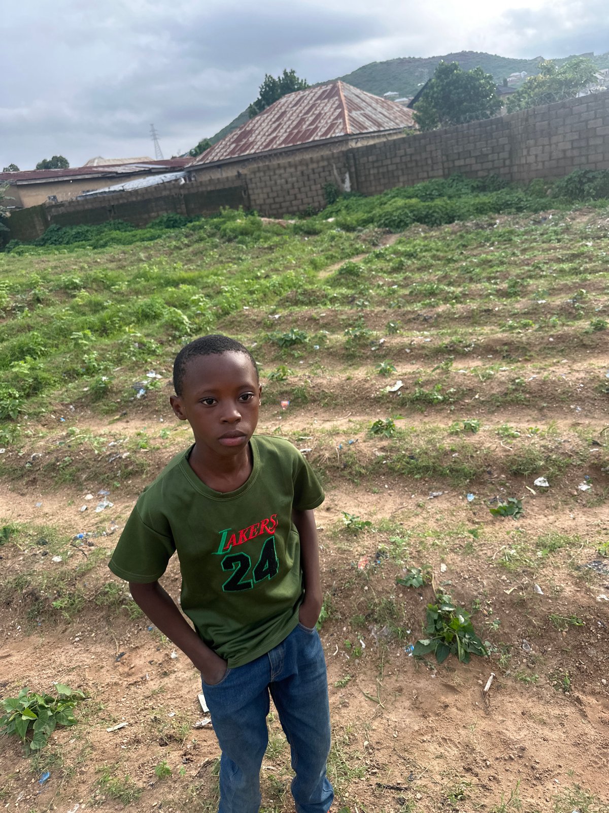 Kids and pickup soccer on a dusty Rukuba Road field
