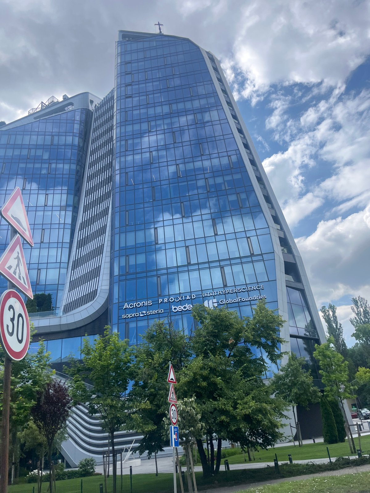 Hotel Vega Sofia's curved glass facade from two angles