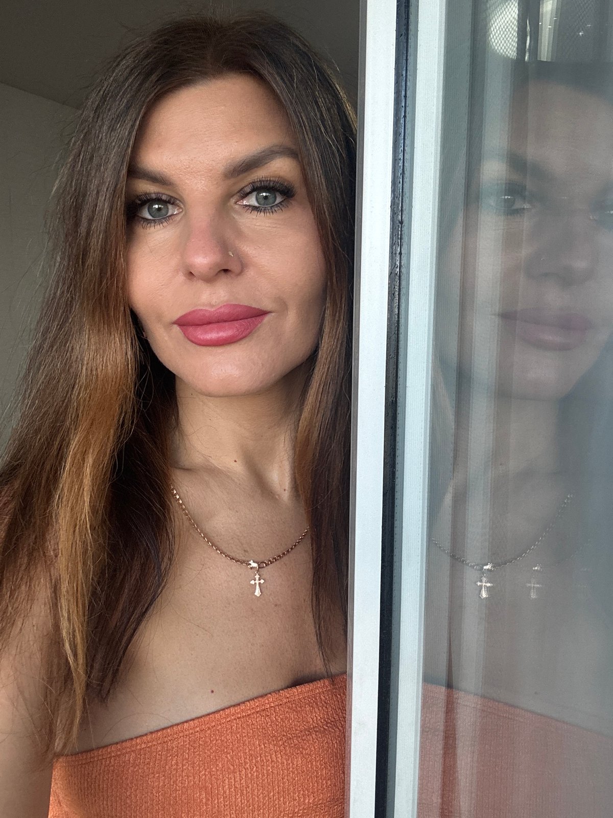 Woman photographs herself indoors in Chaikovsky, Russia