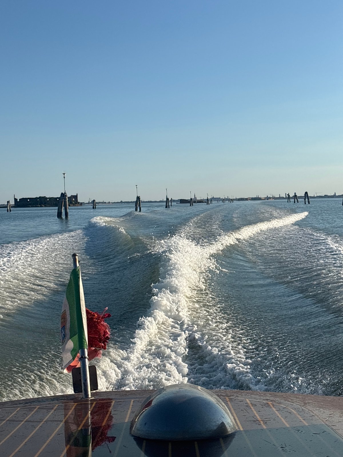 Boat wake on sun-lit Venice canals
