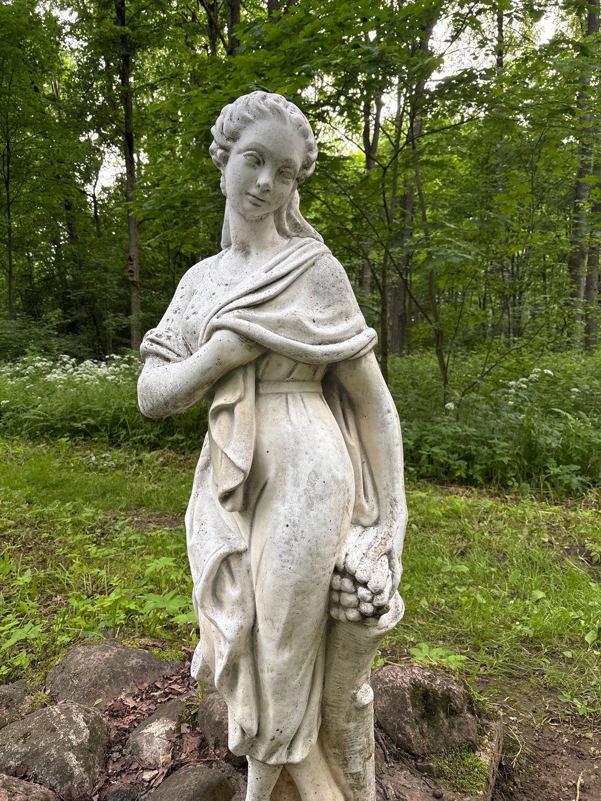 Weathered stone statue and spring at a Gorki park
