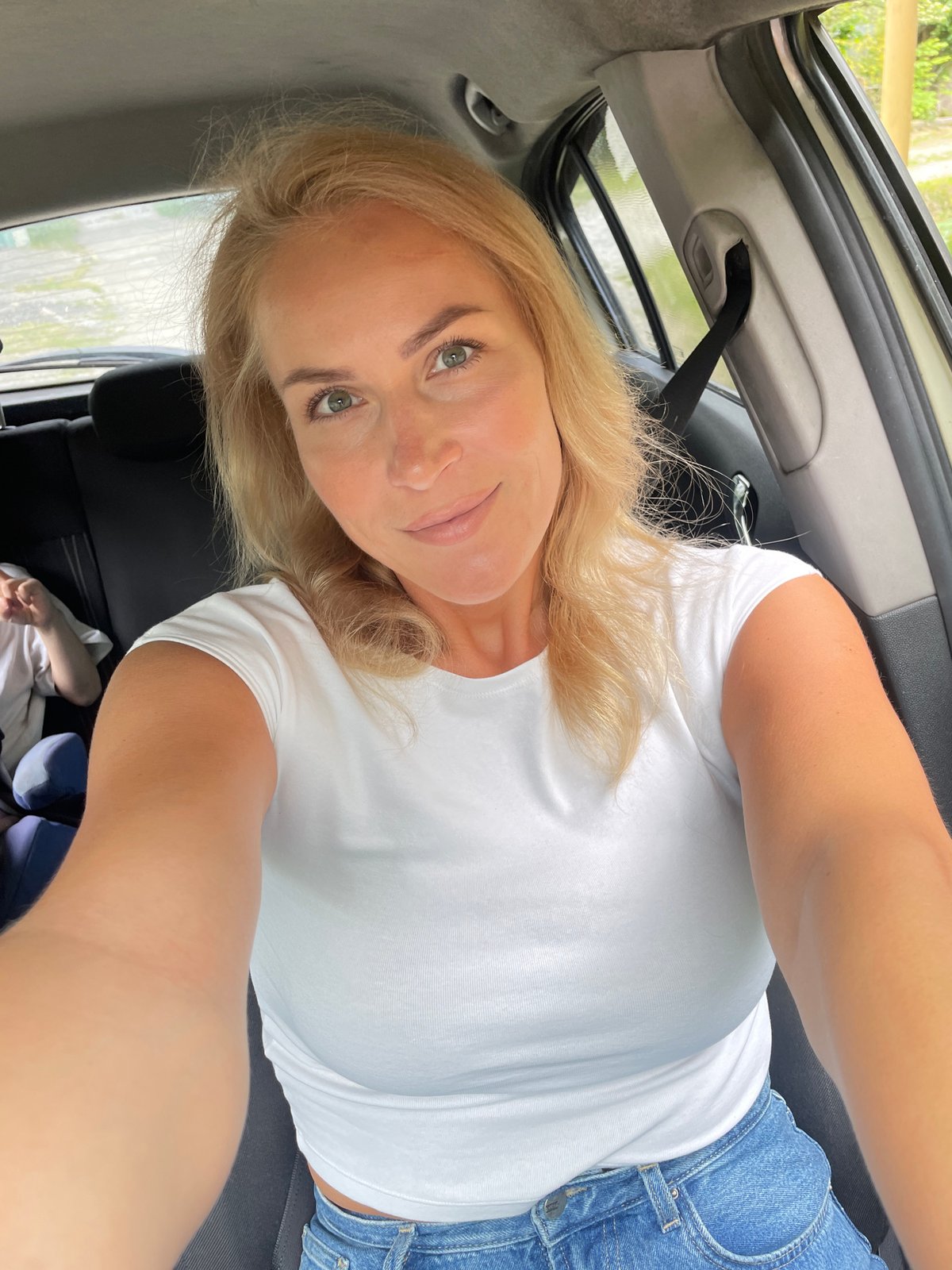 Woman and child photographed in car in Baranovka