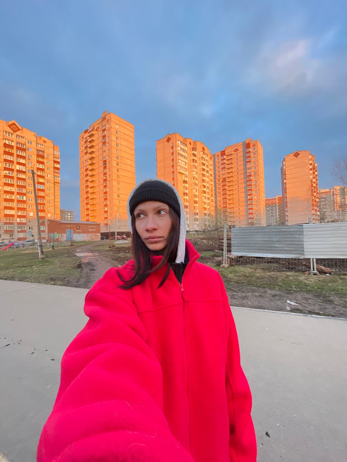 Woman photographed with dog in urban Izhevsk setting