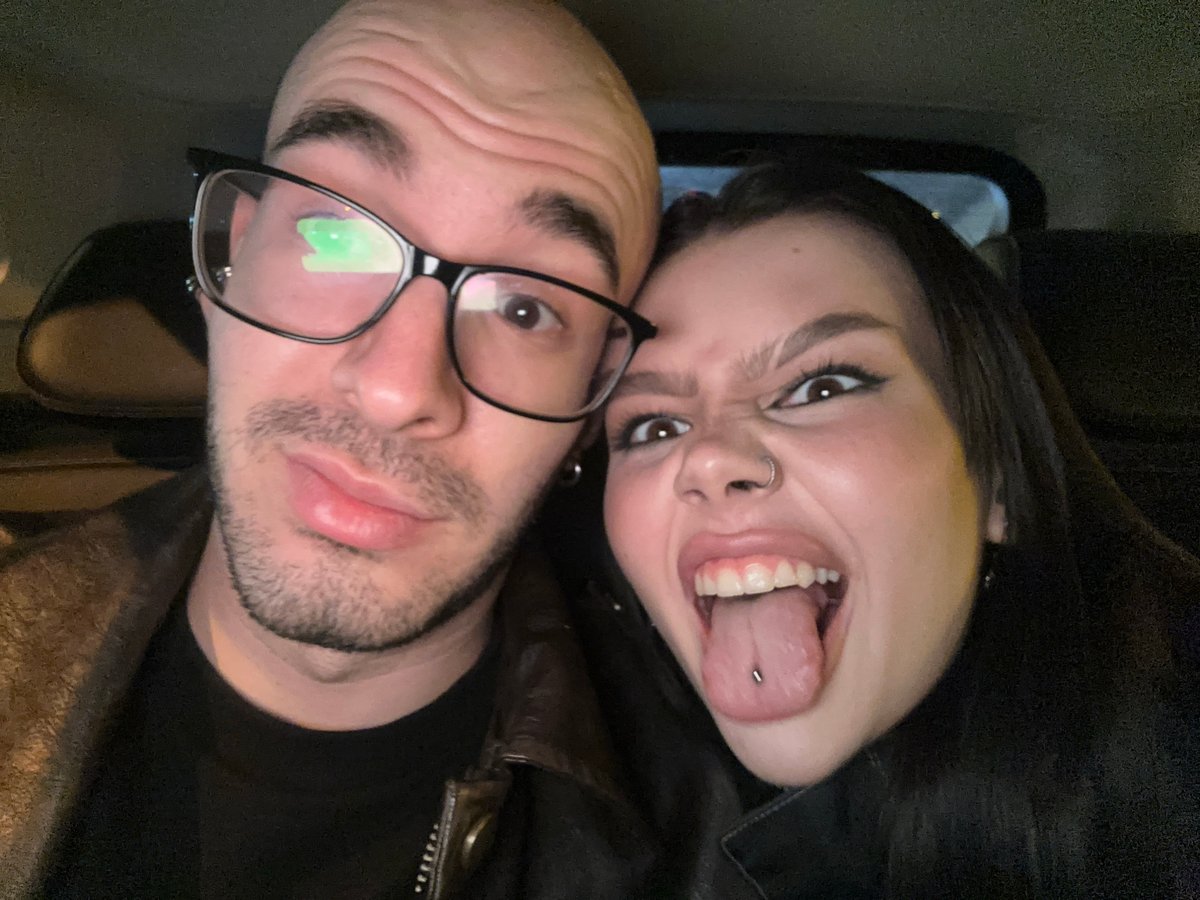 Couple takes playful selfies in car in Moscow