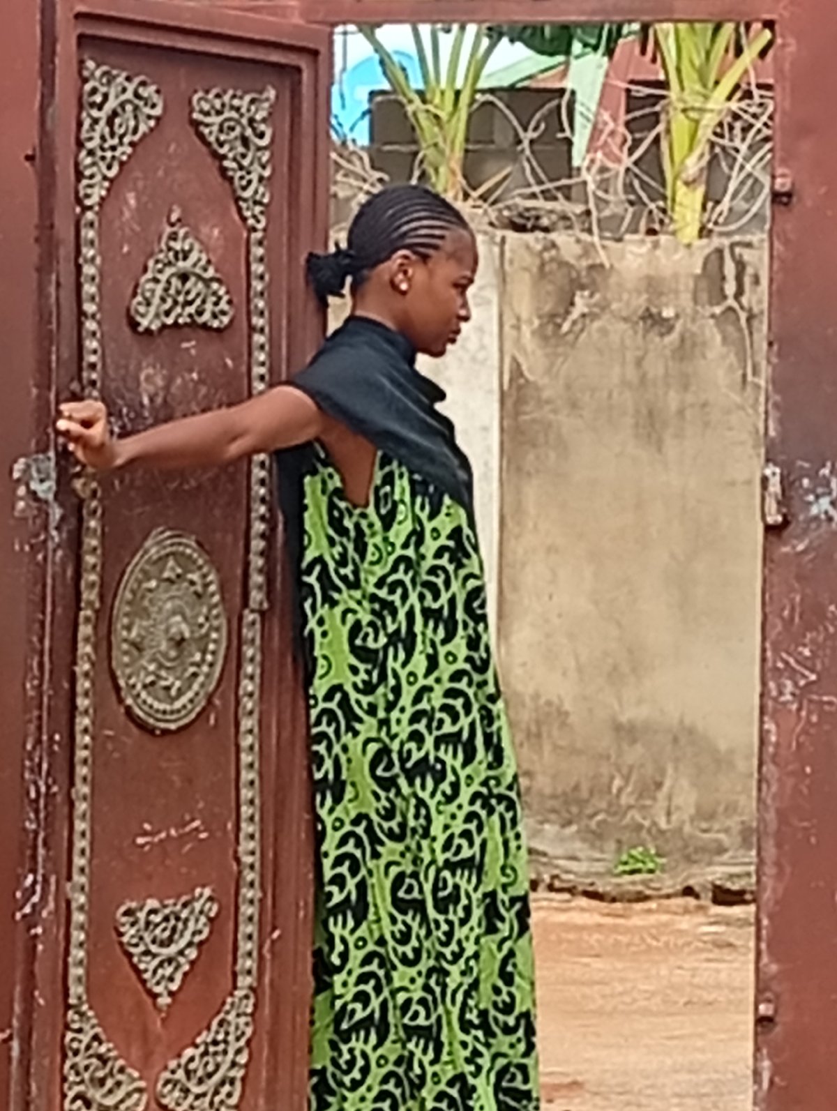 Women in traditional dress observed in doorways, outdoor locations