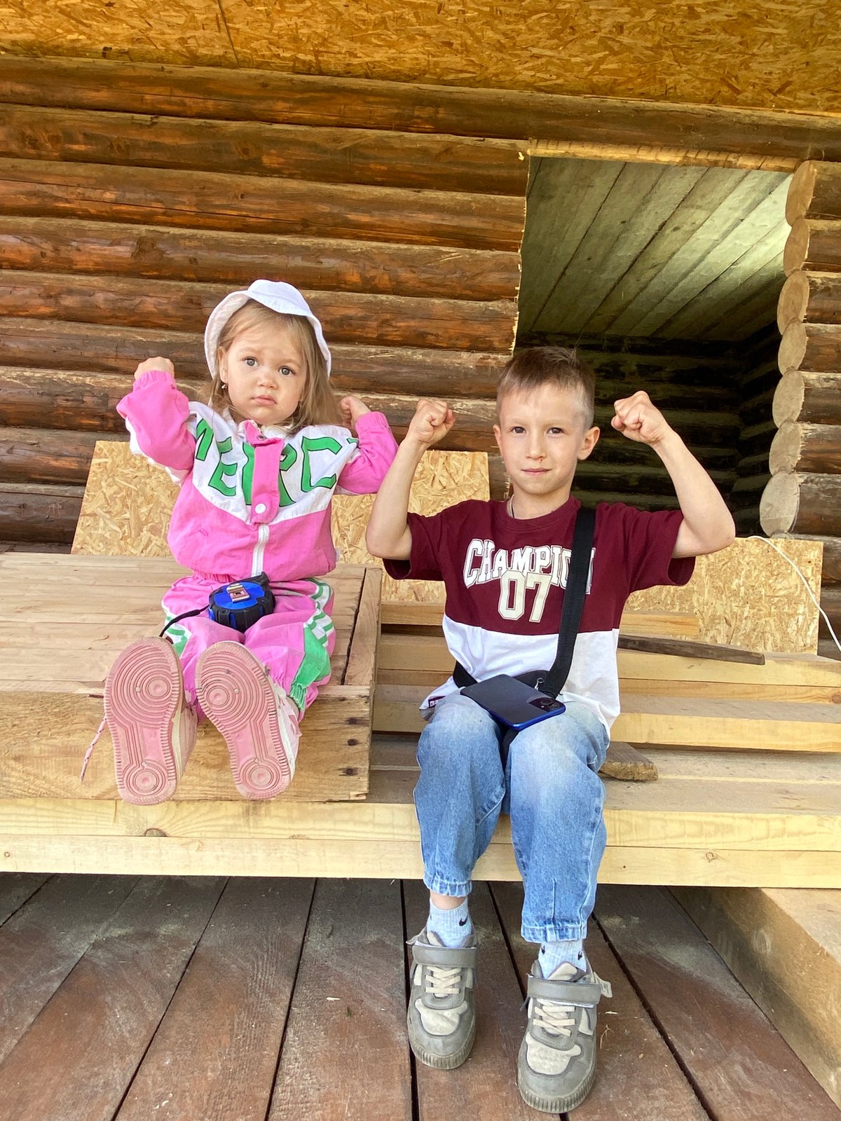 Family moments captured at log cabin construction site in Chaikovsky