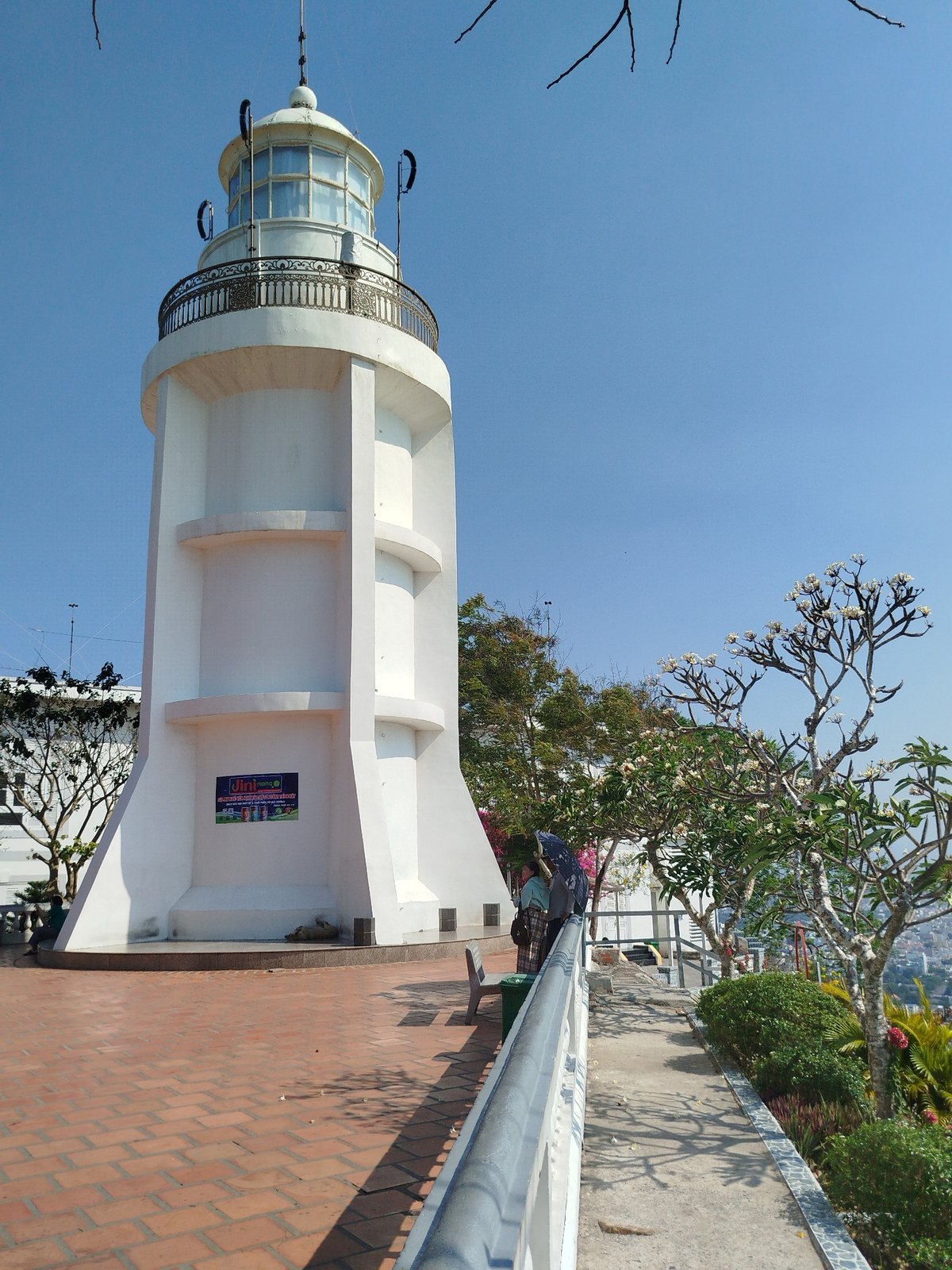 White lighthouse on brick platform documented in Ho Chi Minh City