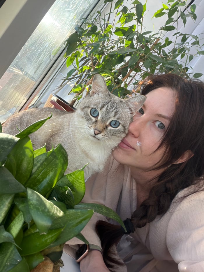 Woman documents morning routine with skincare and cat in Perm