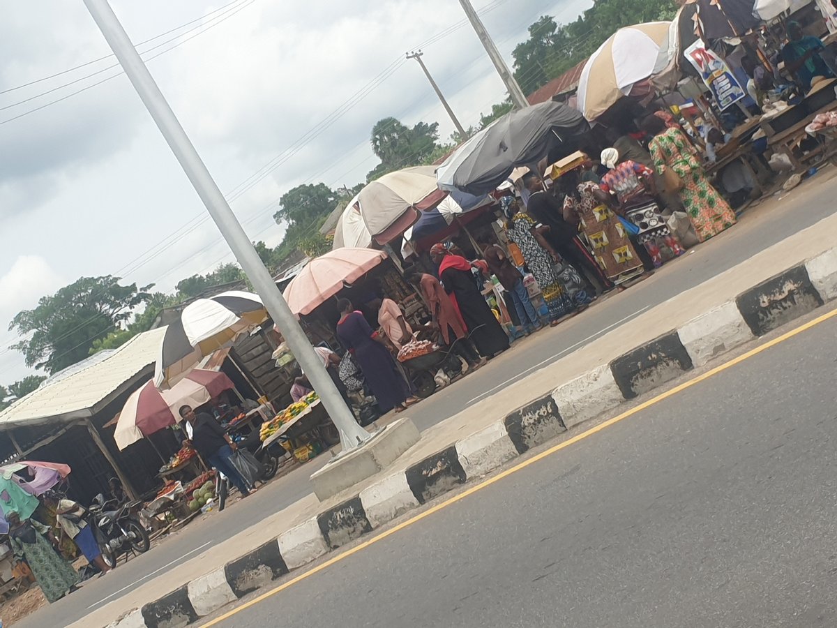 Nigerian market towns show typical midday commercial activity