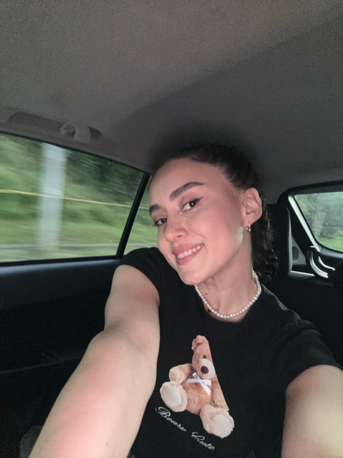 Woman in teddy bear shirt rides through Tbilisi