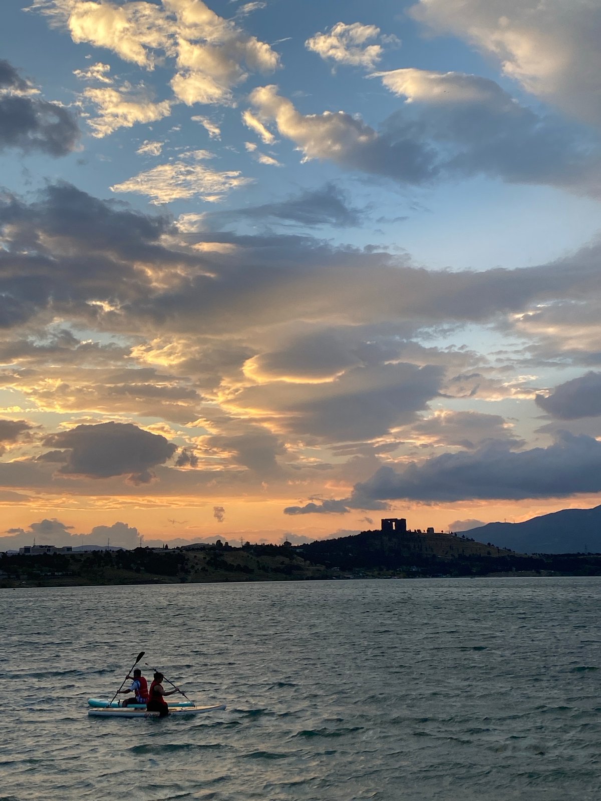 Paddleboarding on Tbilisi Sea at a dramatic summer sunset