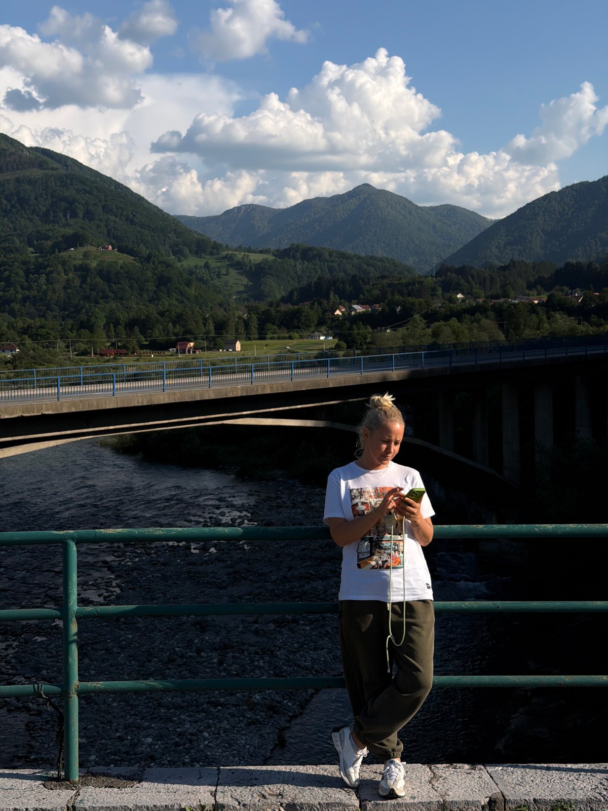 Visitors photograph scenic river bridge in Mojkovac Montenegro