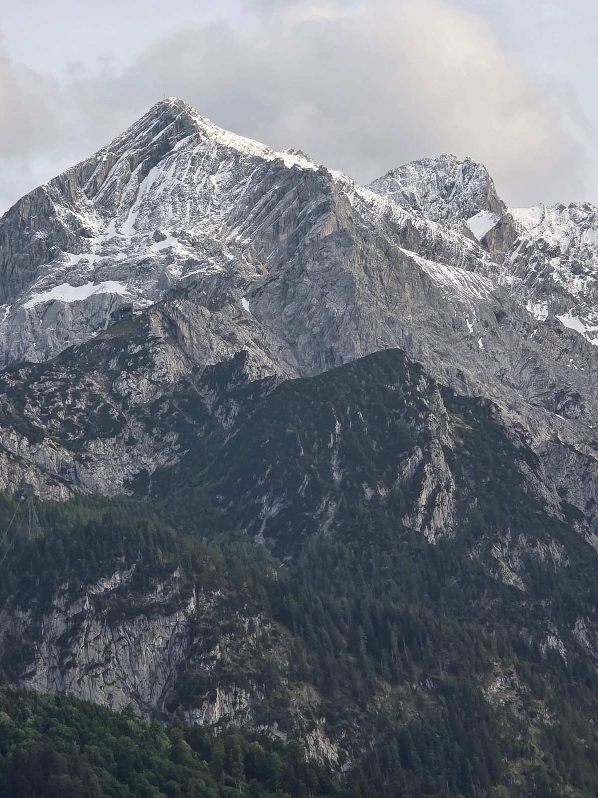 Mountain range with cross-topped peak documented by witness