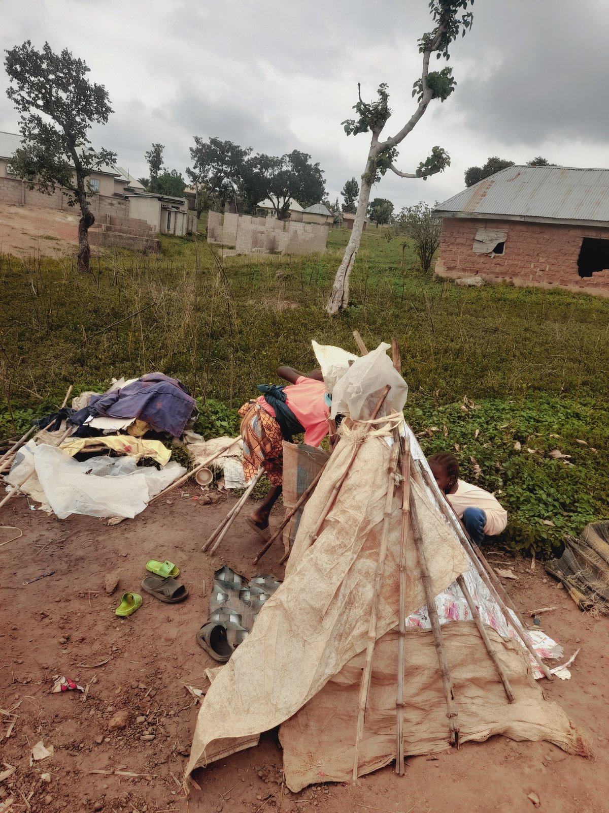 Children build makeshift shelters in Akwanga, Nigeria