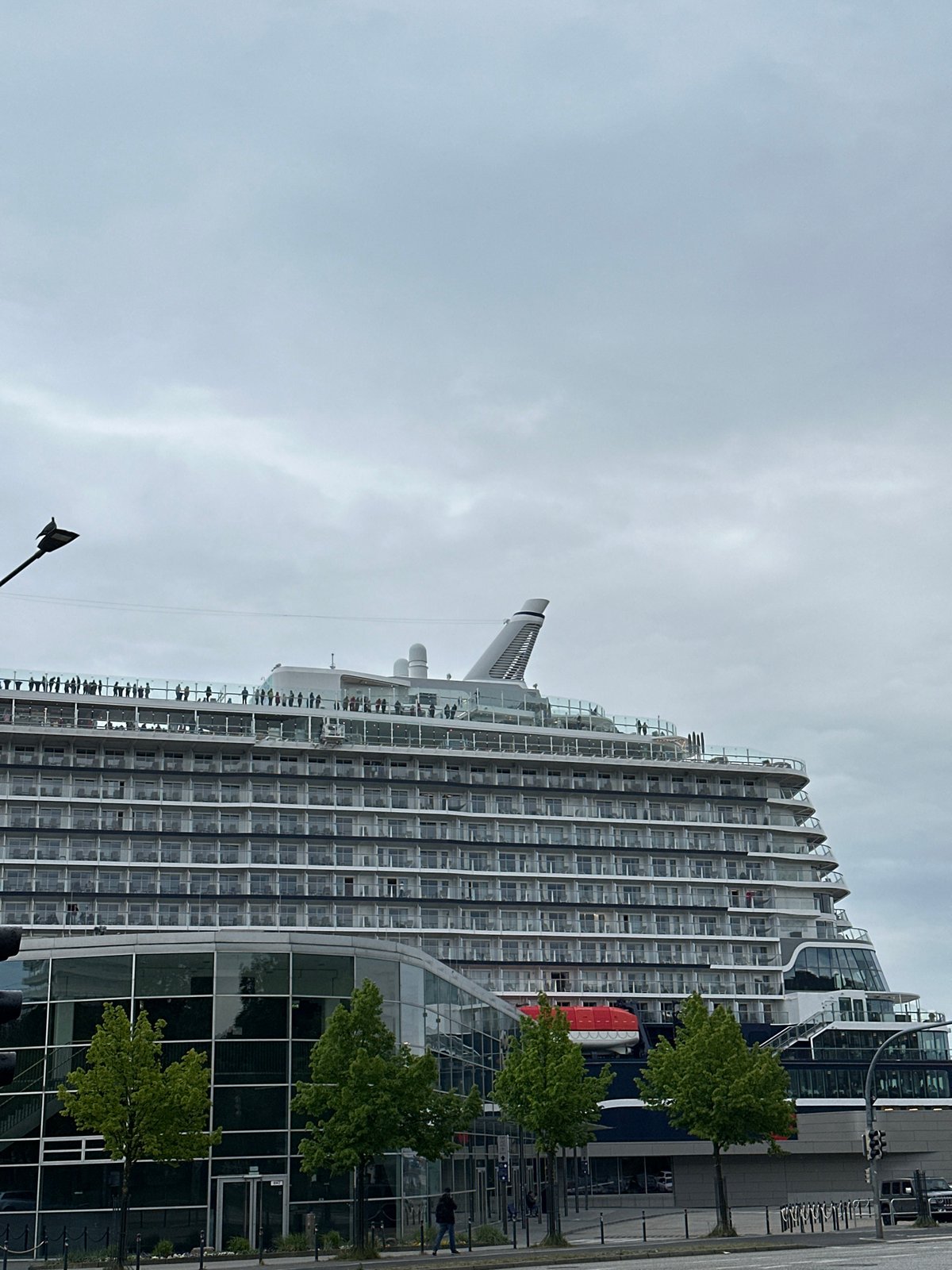 TUI cruise ship docked at Kiel port, passengers visible