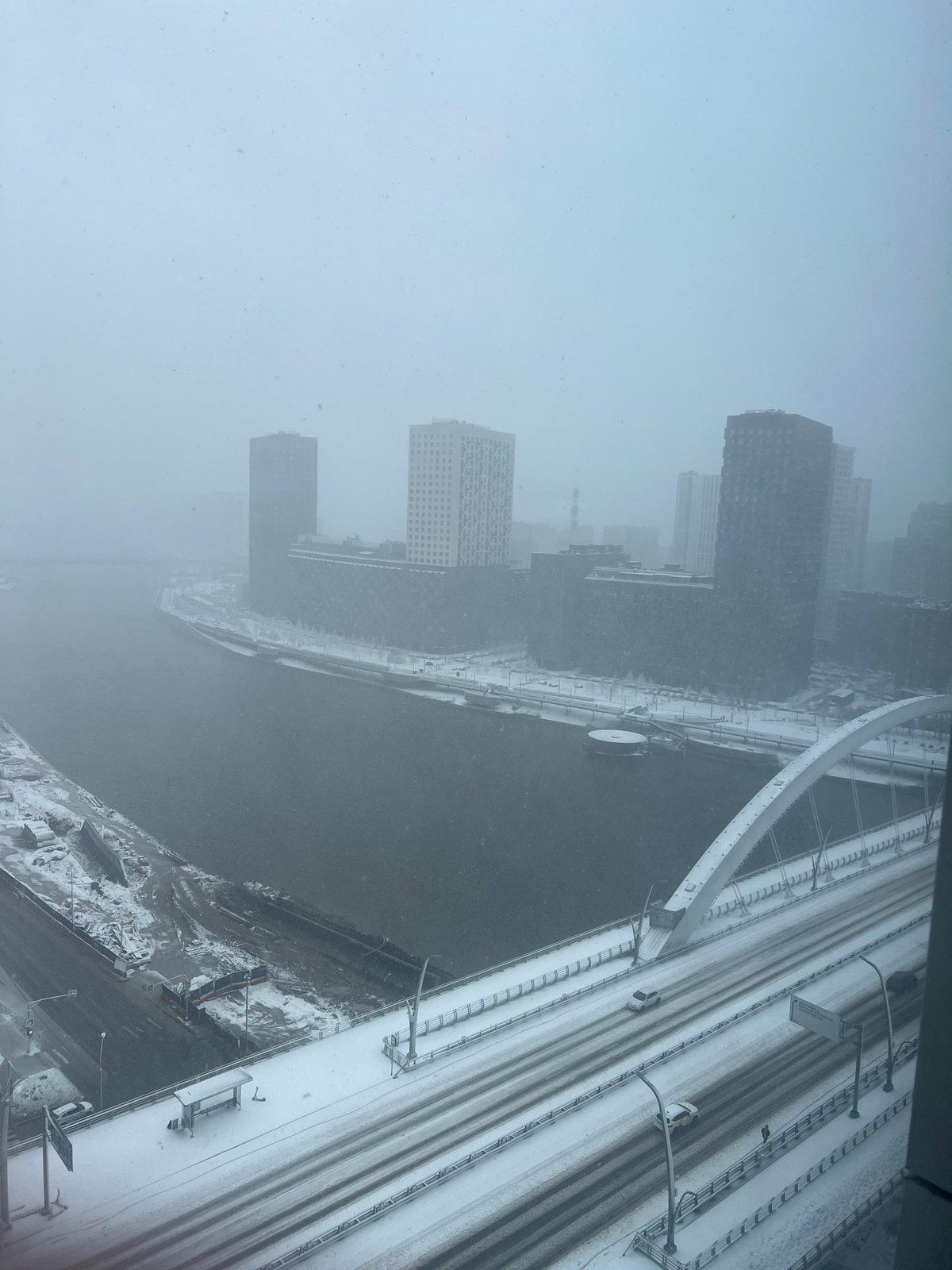 Spring snowstorm blankets Khimki infrastructure, buildings partially obscured