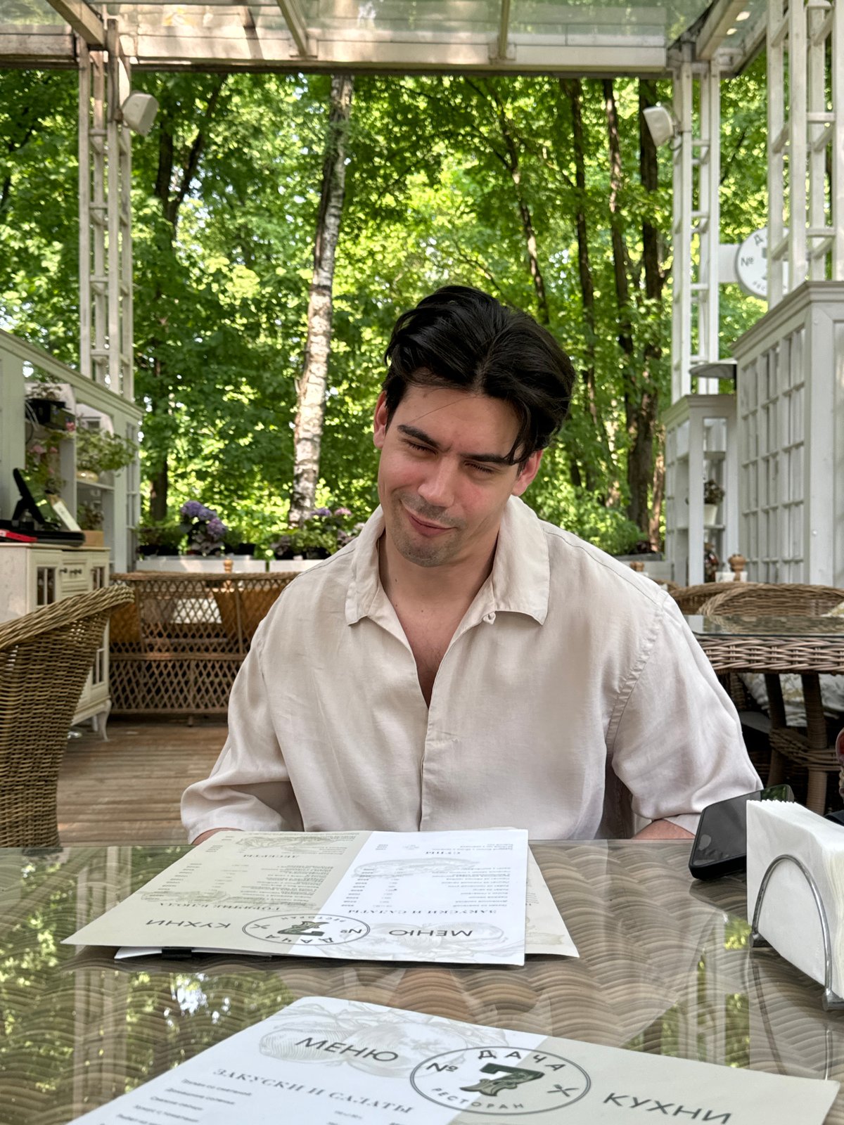 Man feeds ducks during outdoor breakfast in Arkhangel'skoye