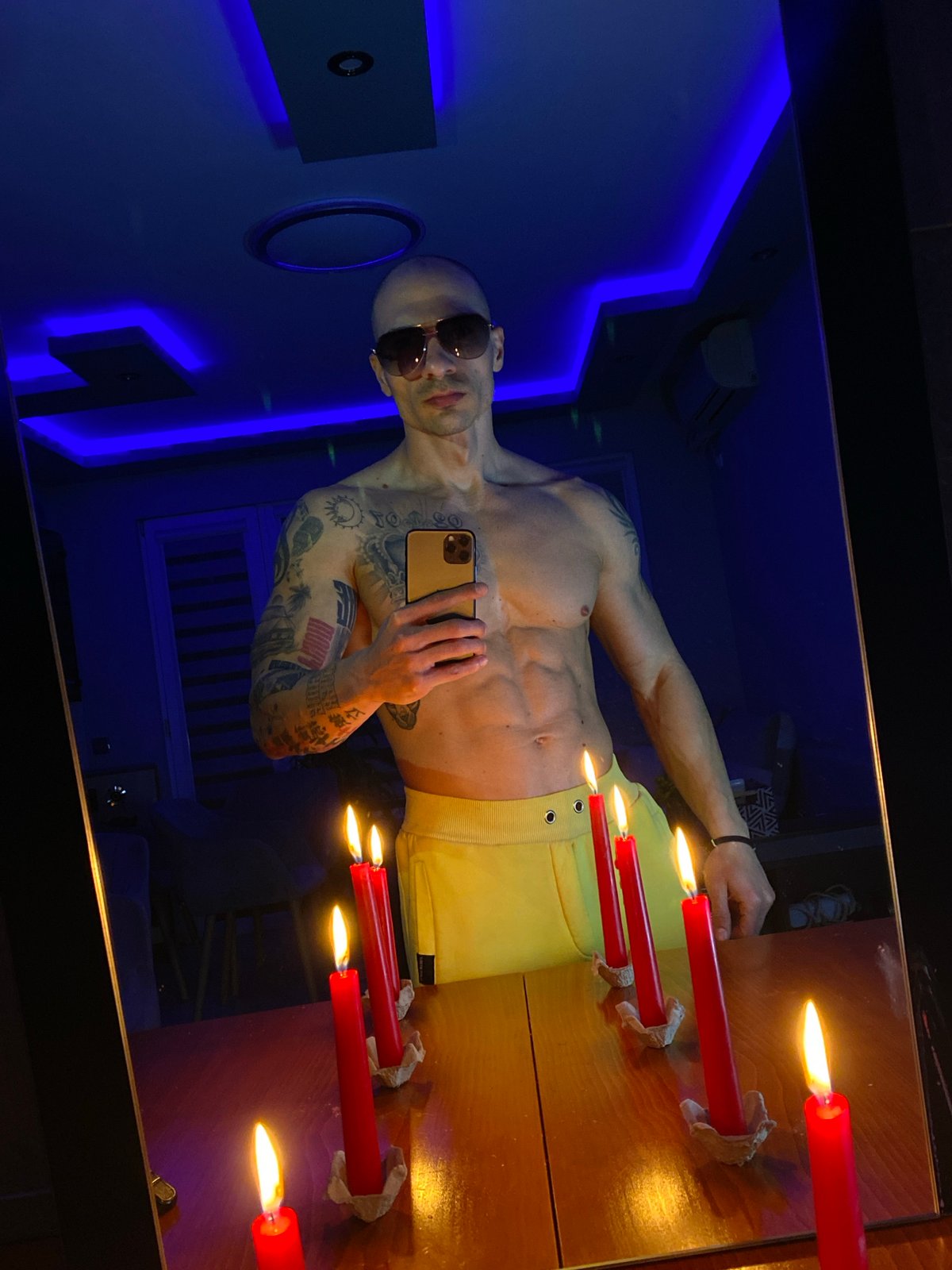 Man takes mirror selfie in neon-lit room in Pleven