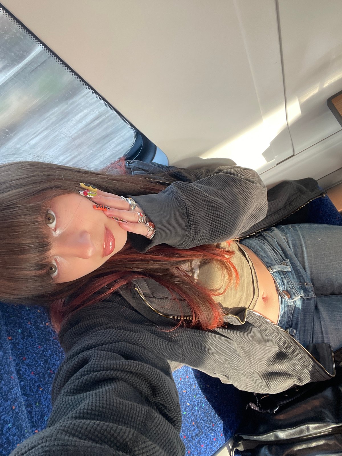 Person rests on train seat in Ramat HaSharon