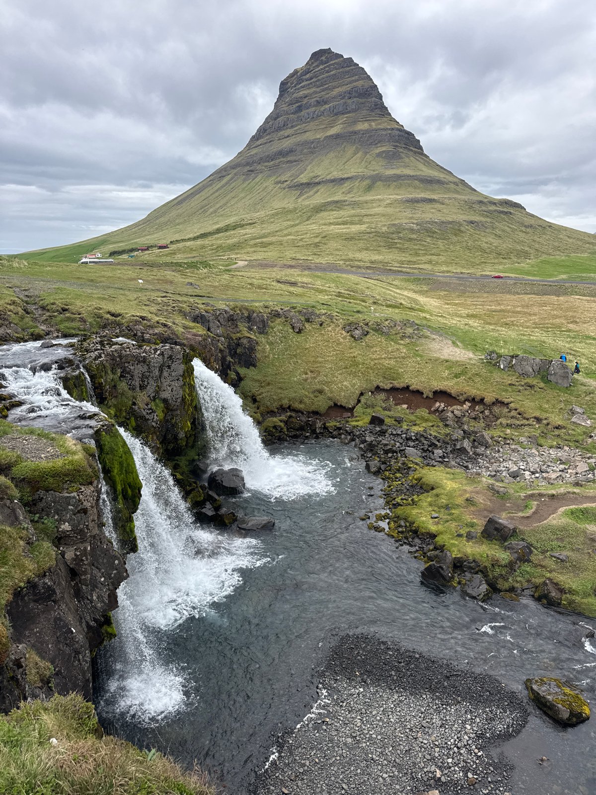 Visitors document iconic Kirkjufell mountain and waterfalls in Iceland