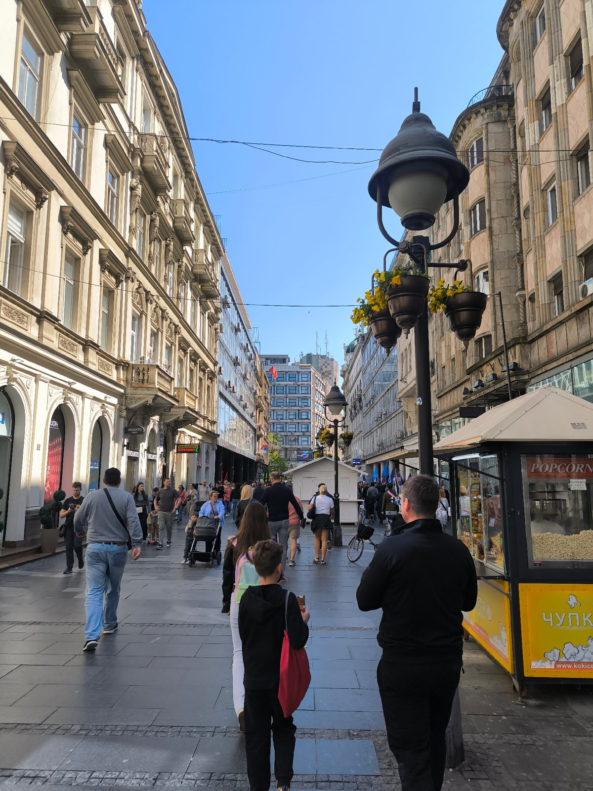 Sunny day pedestrian activity observed on Belgrade street